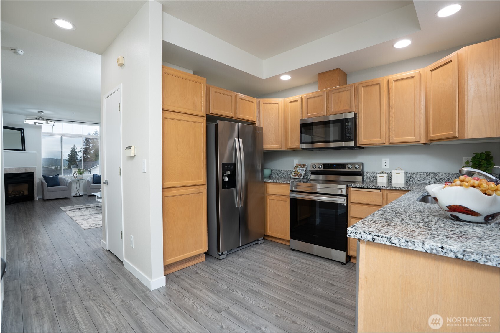 The kitchen seamlessly connects the living and dining areas, creating an open, cohesive space perfect for everyday living and entertaining.
