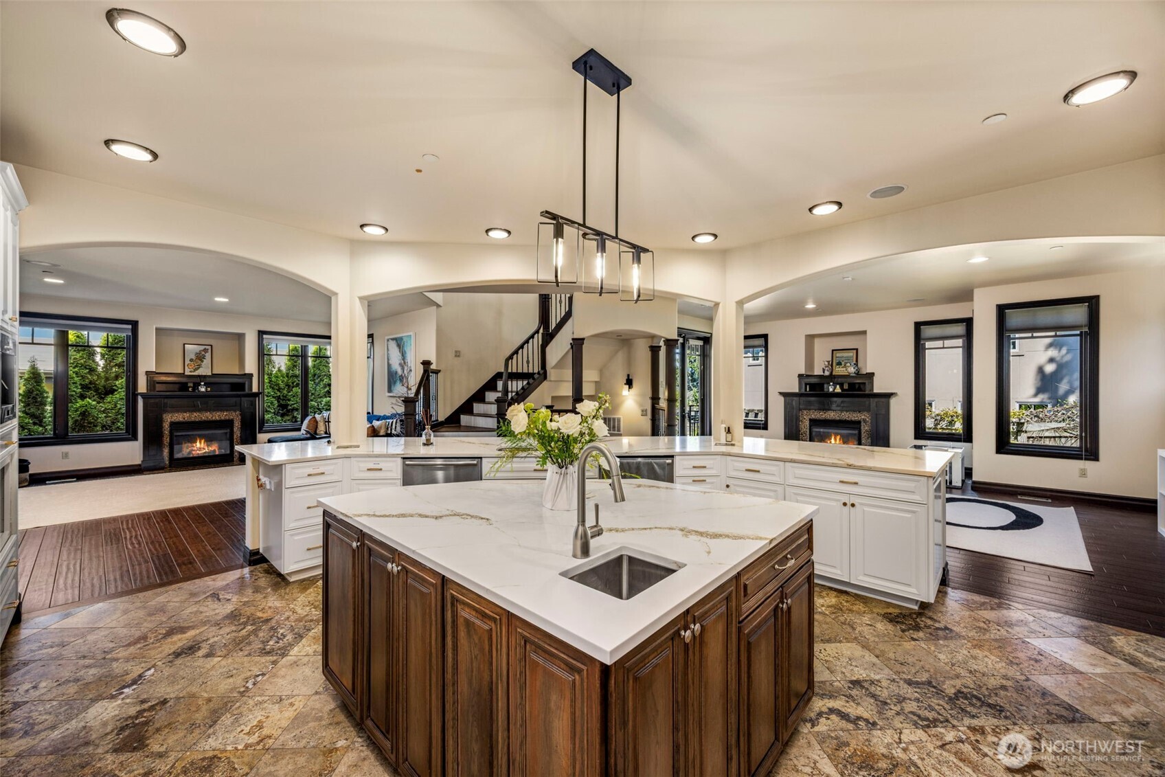 Main Floor Kitchen: Chef's kitchen with expansive quartz island, designer pendants, and seamless flow to the family room.