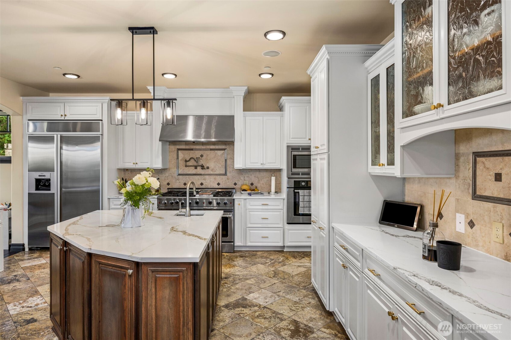Main Floor Kitchen: Professional-grade range and hood anchor the kitchen, complemented by white cabinetry.