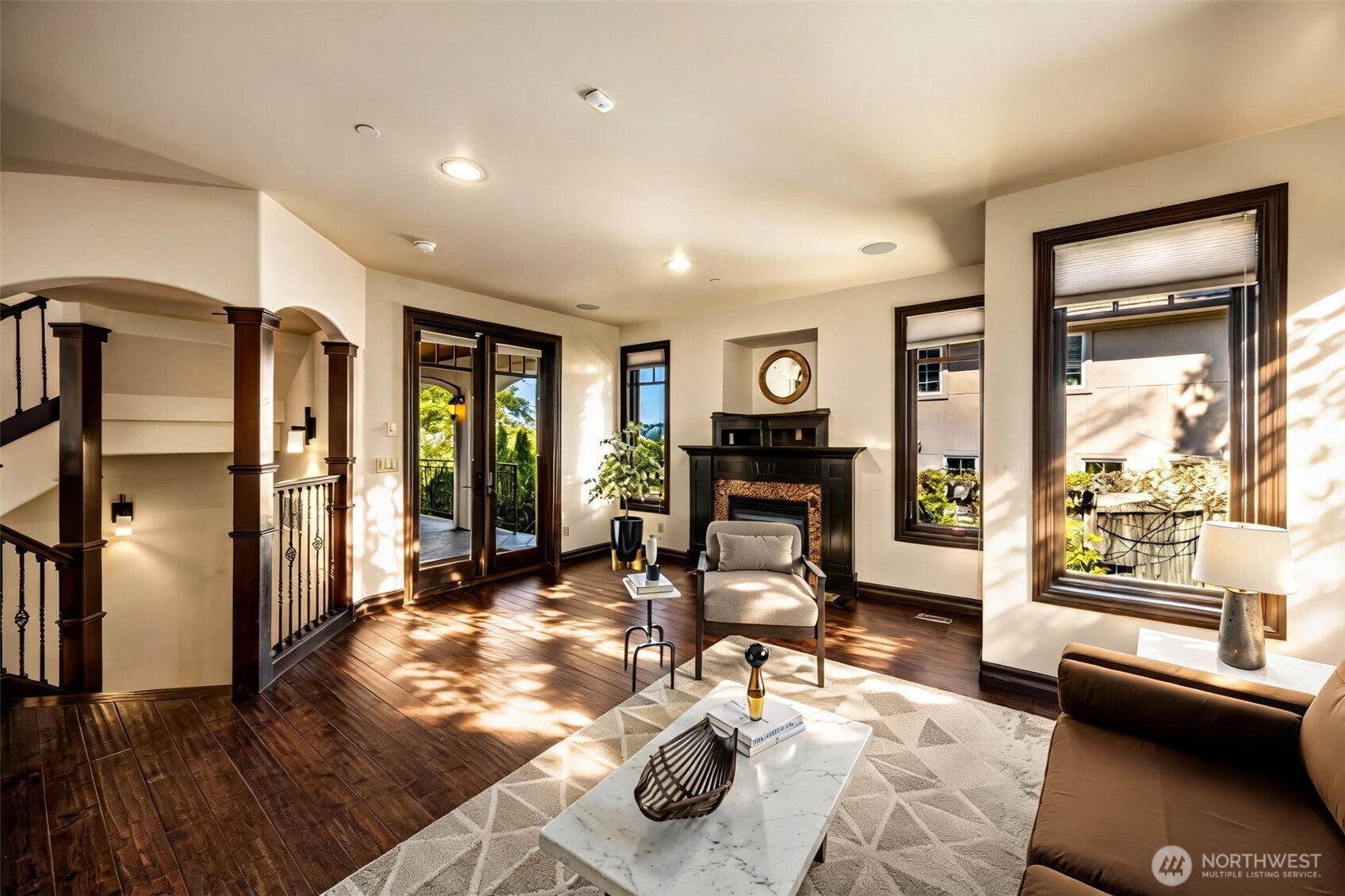 Main Floor Living Room: Open living area with fireplace and graceful archways leading to the main hallway.
