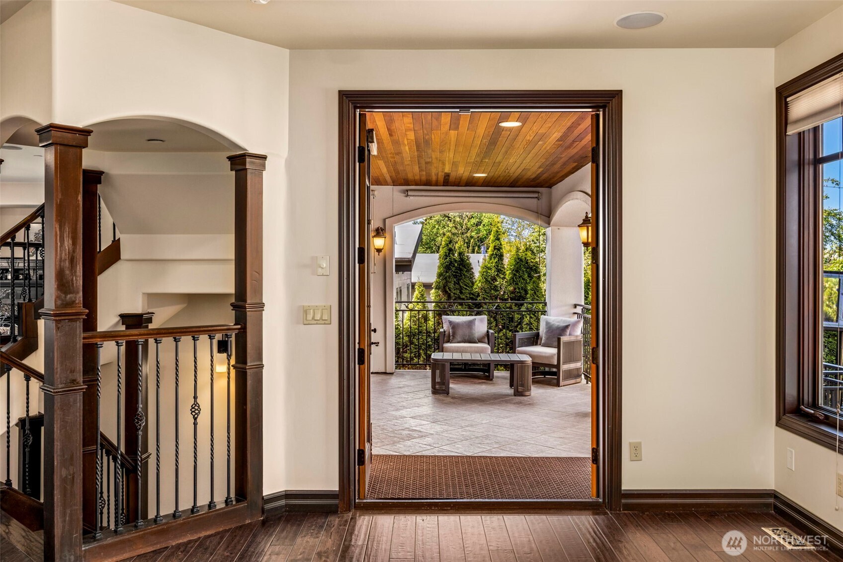 Main Floor Living Room: Hallway view showcasing the home's signature arched openings and thoughtful flow between roo