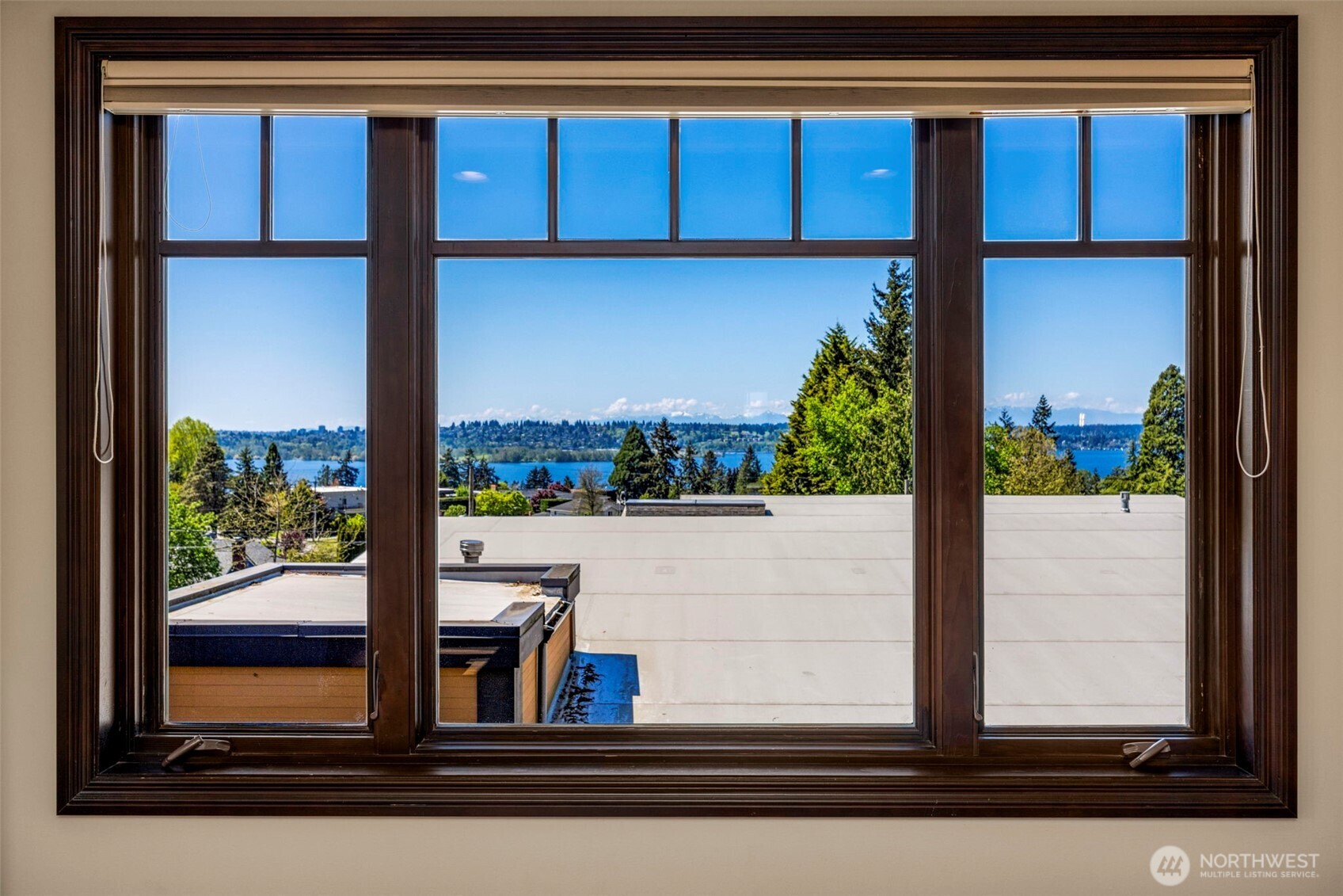 Upper level Primary bedroom with view: Captivating views of the Olympics and Puget Sound from the Primary Suite's view-swept windows.
