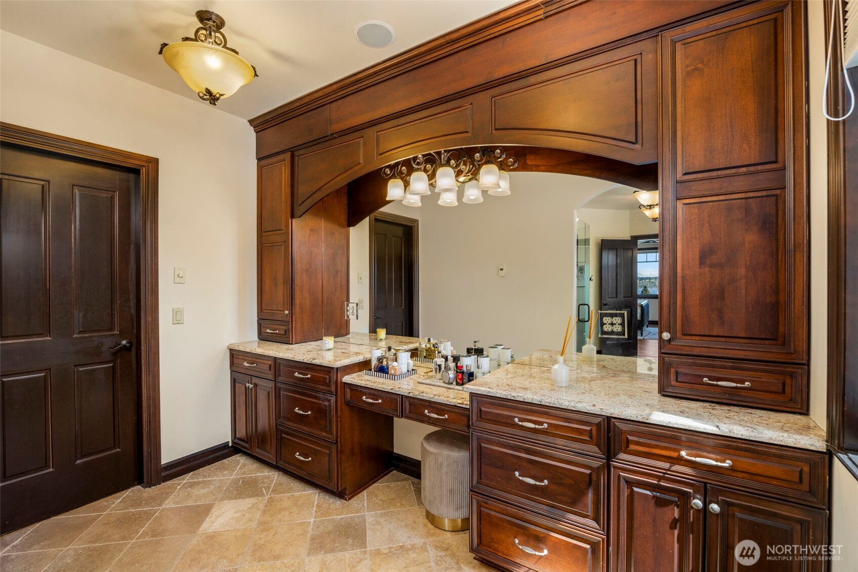 Primary bedroom Vanity: Custom built-in vanity with rich wood cabinetry — a refined dressing area within the Primary Suite. Heated floors.