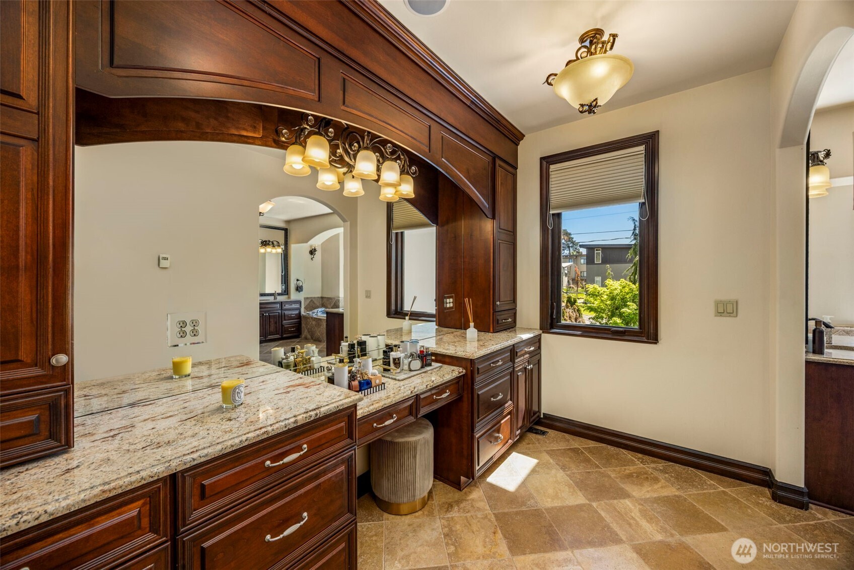 Primary bedroom Vanity: Expansive Primary vanity, designer lighting, and ample storage. Heated floors.