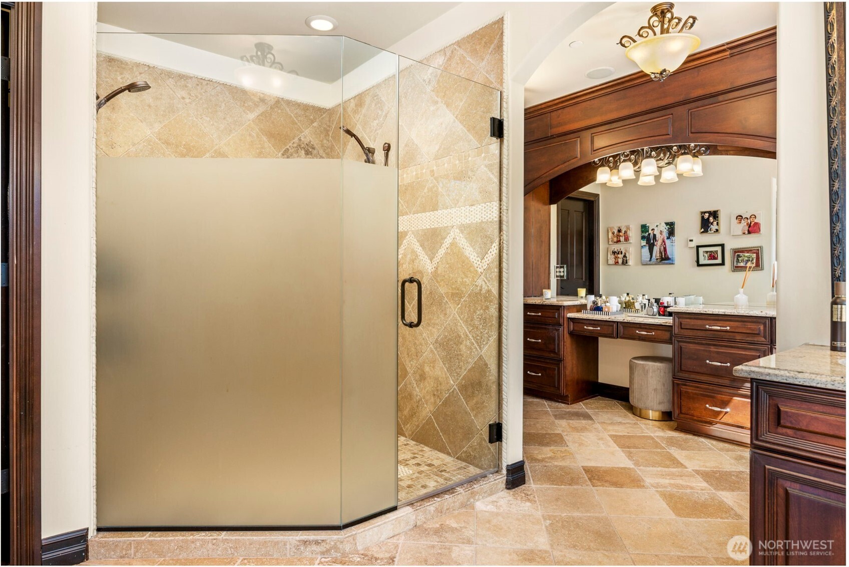 Lower level bathroom: Lower-level bath featuring tiled shower, granite vanity, and warm wood cabinetry.