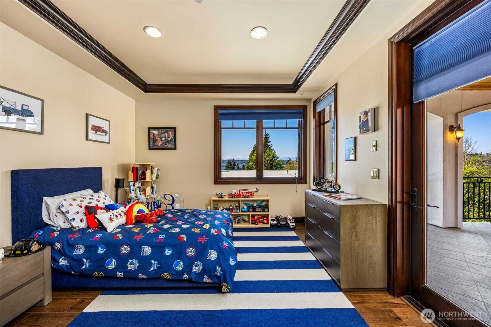 Lower level bedroom: Spacious lower-level bedroom suite with rich wood trim, abundant natural light, and serene outlook.