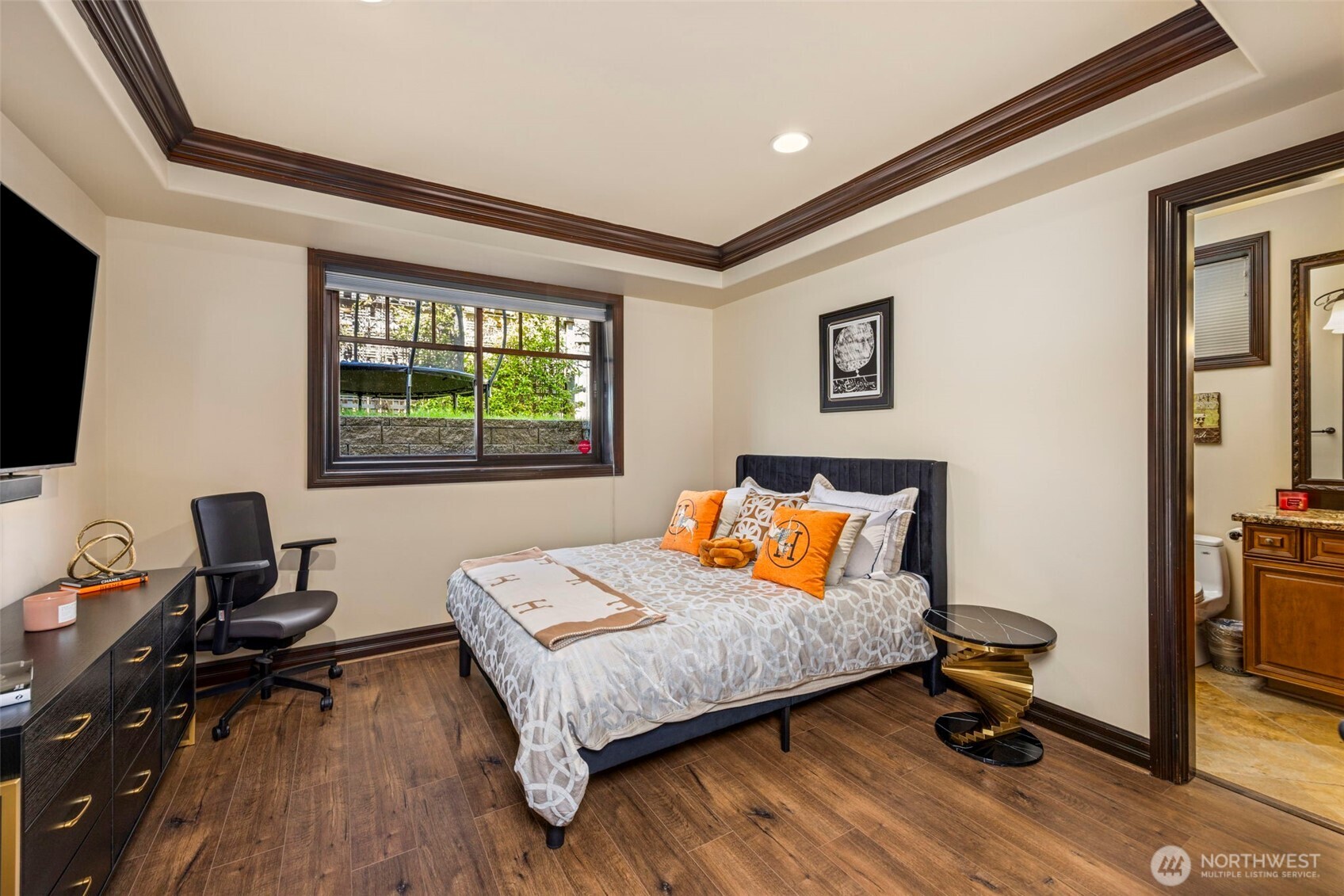 Lower level rec room: Spacious lower-level recreation room with cozy fireplace, built-in media area, and comfortable lounging space — ideal for movie nights or casual gatherings. With fridge and cabinets.