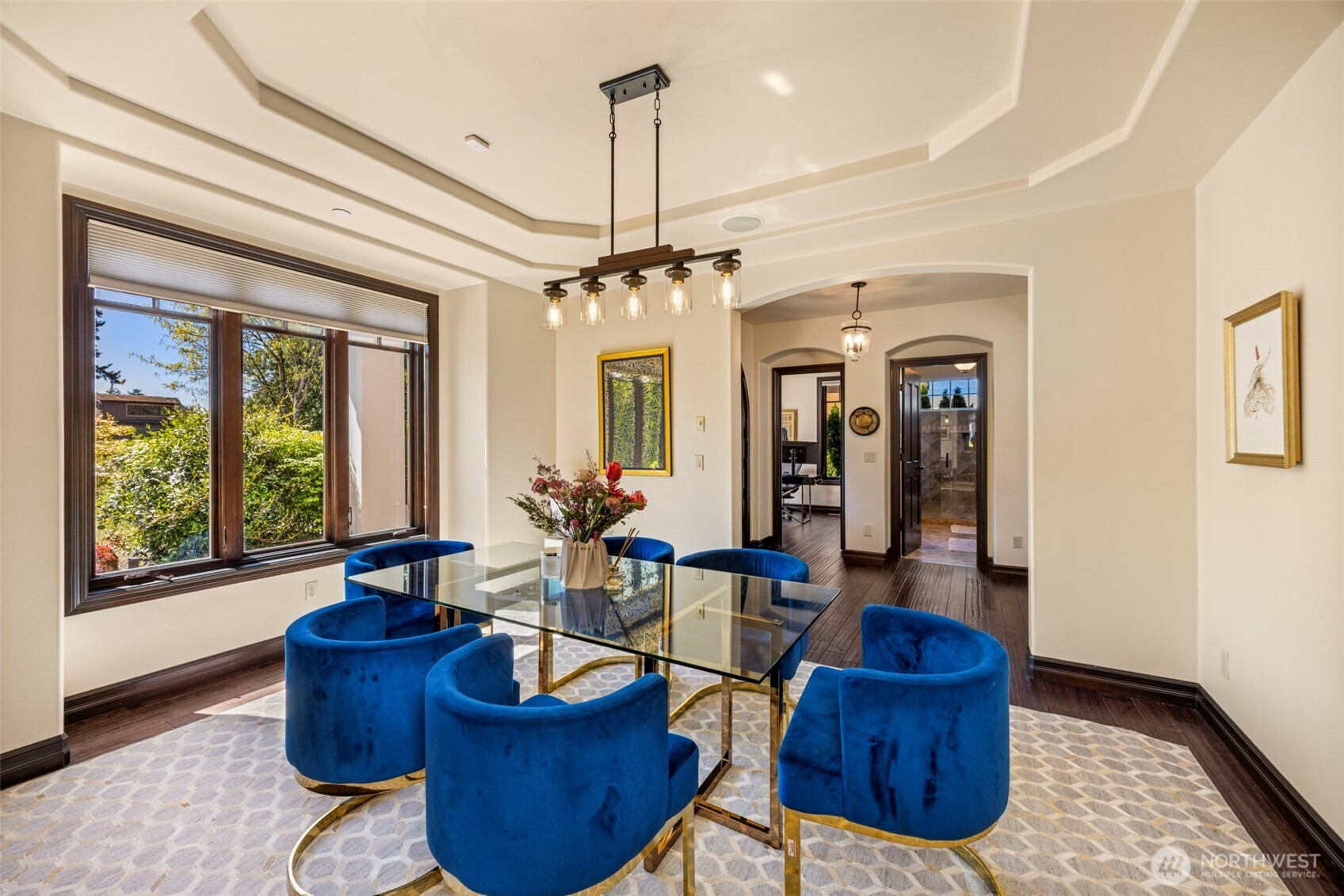 Main Floor Dining Room: Open-concept dining space flowing seamlessly to the living areas, framed by graceful archways.