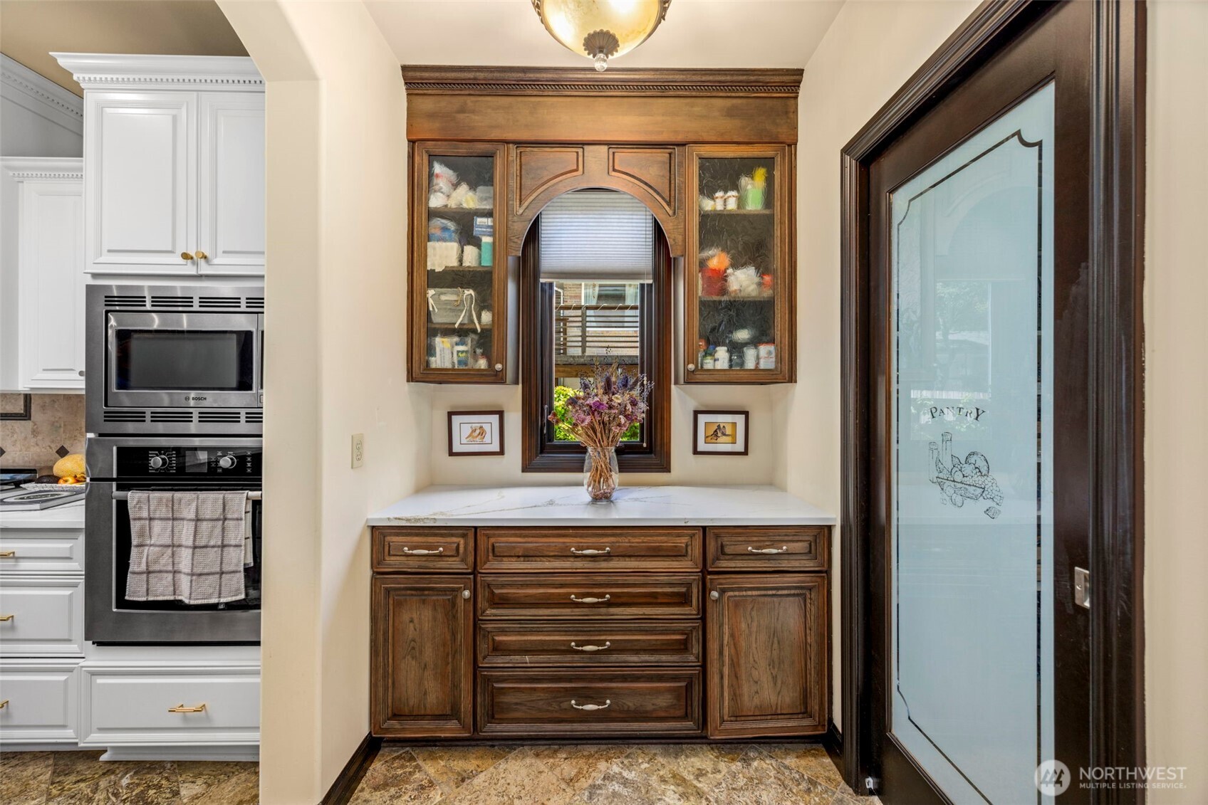 Butler's Pantry: Refined butler's pantry with custom cabinetry, connecting kitchen to dining room.