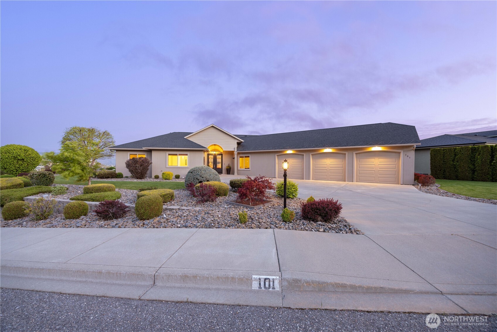 Elegant street presence in Crystal View Estates, where refined architecture meets thoughtful landscaping. This beautifully maintained home welcomes with a wide driveway, manicured grounds, and a spacious multi-car garage, offering both function and curb appeal. Clean lines, warm exterior tones, and inviting entry create a polished first impression in one of Lake Chelan’s premier communities.