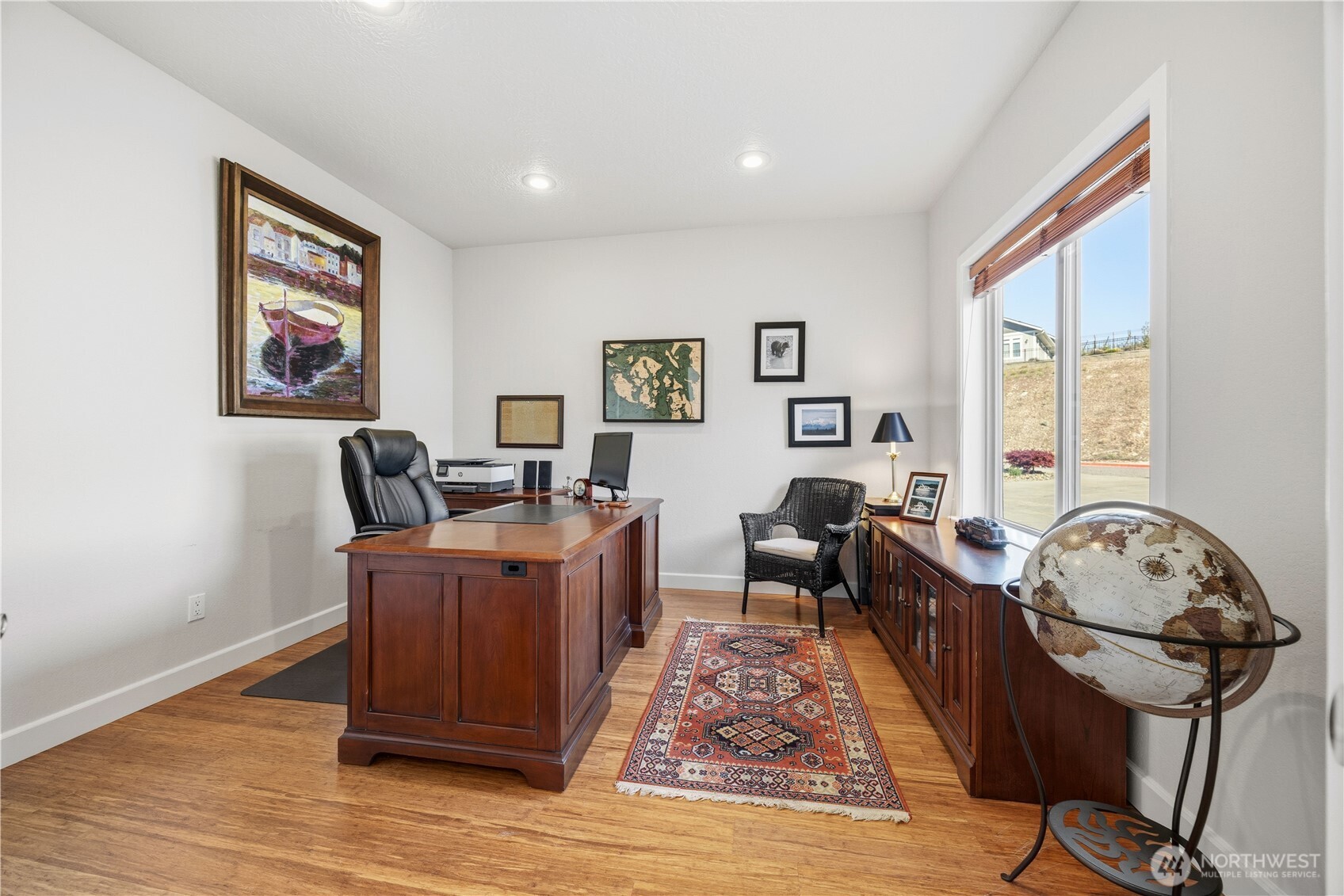 Versatile bedroom or home office offering a quiet, light-filled setting with large windows and clean, neutral finishes. Ideal for remote work or guest accommodations, this flexible space provides comfort, functionality, and privacy.