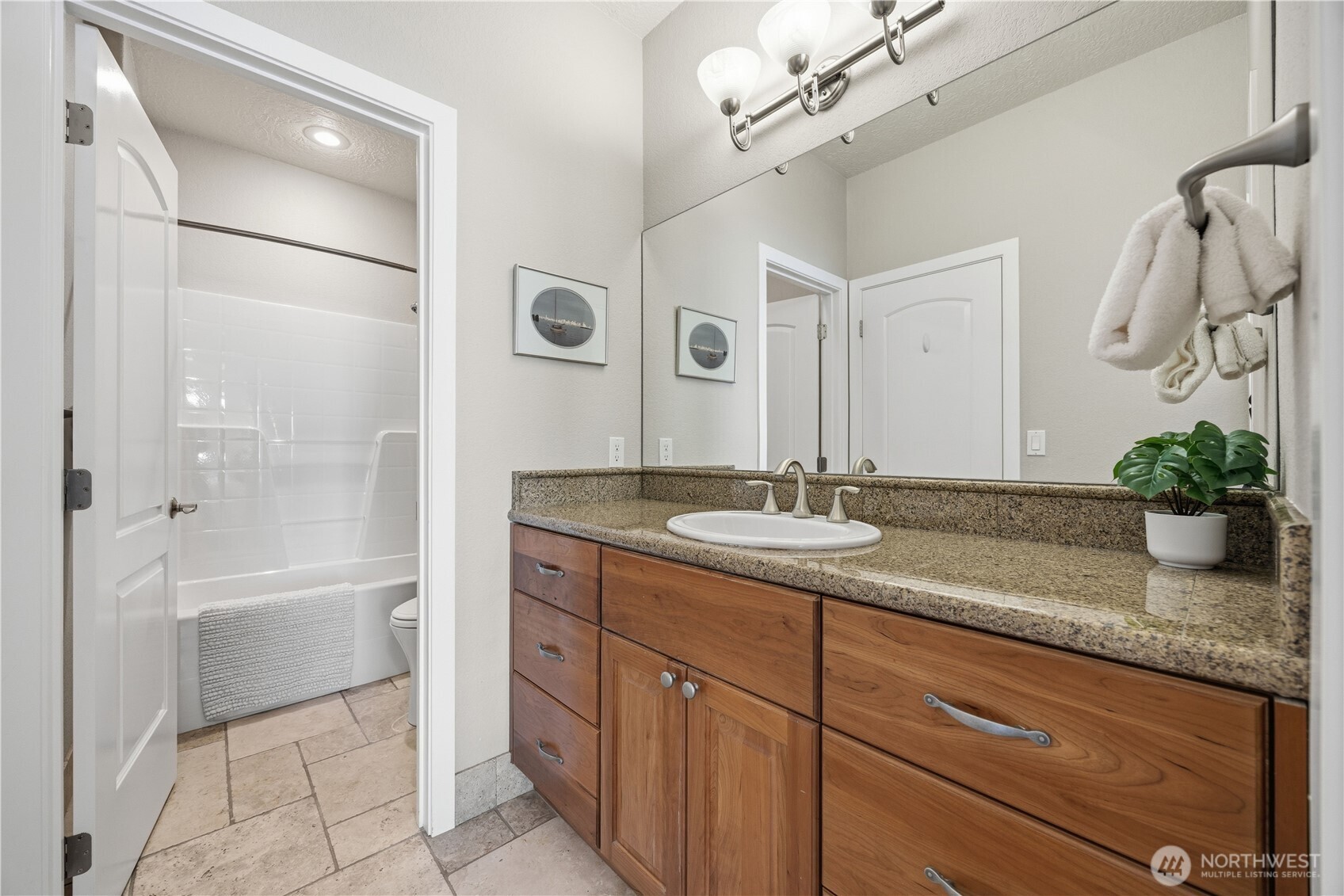 Well-appointed guest suite/guest bath featuring a spacious vanity with ample storage, and clean, neutral finishes. A shower/tub combination adds functionality, making this space ideal for both guests and everyday use.