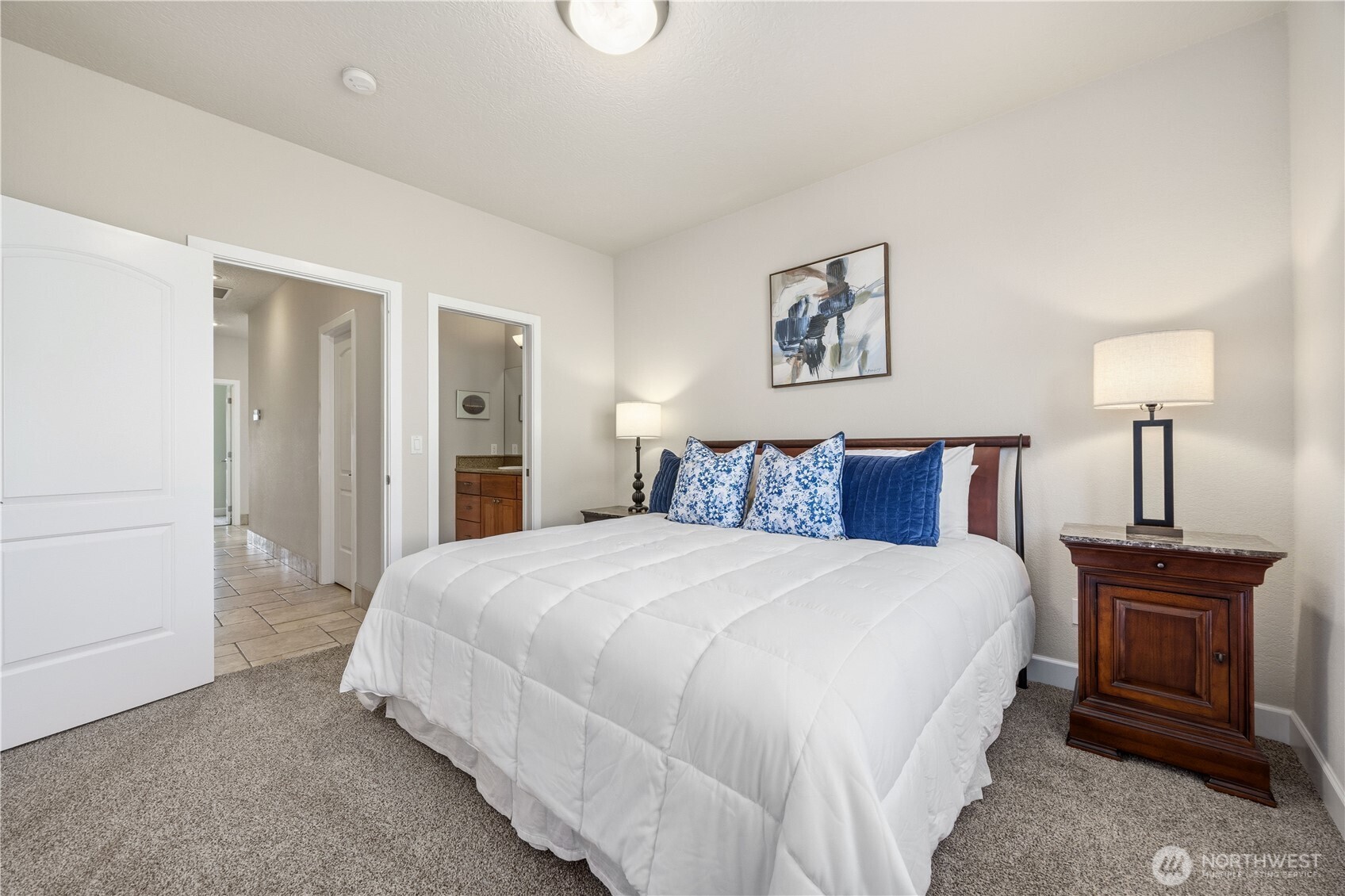 Spacious guest suite featuring plush carpeting, neutral tones, and a light-filled layout. Generous proportions and ample closet space create a comfortable and private retreat for visitors.