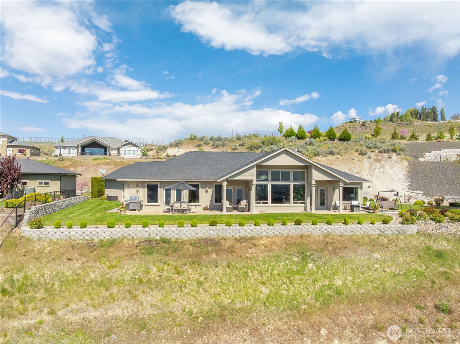 Beautifully positioned residence in Crystal View Estates, set on a spacious lot with expansive lawn and panoramic views of Lake Chelan and the surrounding mountains. The home’s inviting exterior and thoughtfully designed layout blend seamlessly with the natural landscape, offering privacy, space, and an exceptional setting for enjoying the Lake Chelan lifestyle.