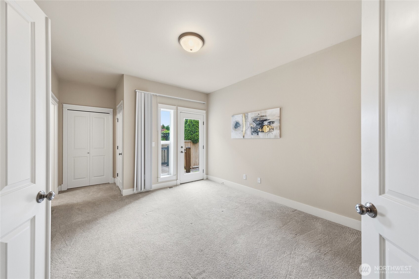 Main-level primary bedroom with private deck and separate entrance—ideal for guests or multi-generational living