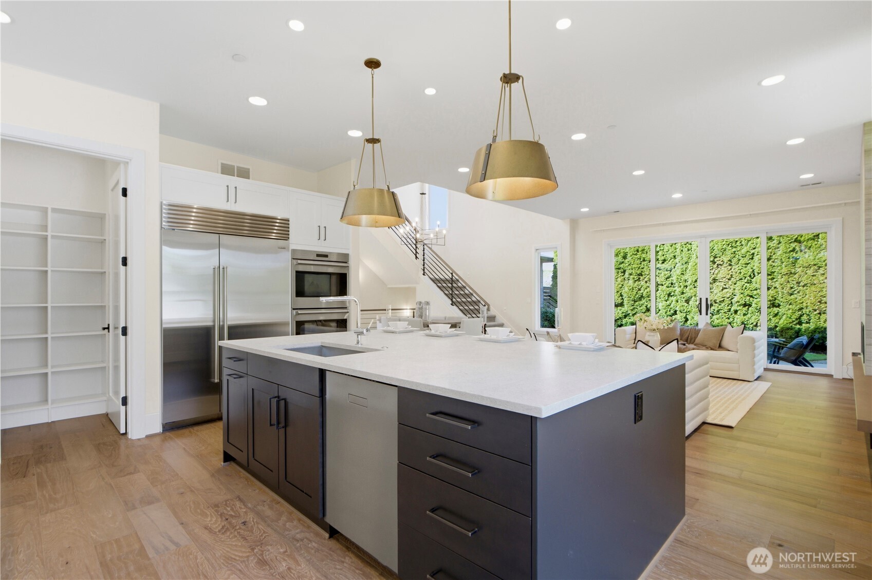 Beautiful pendant lighting enhances the oversized kitchen island!