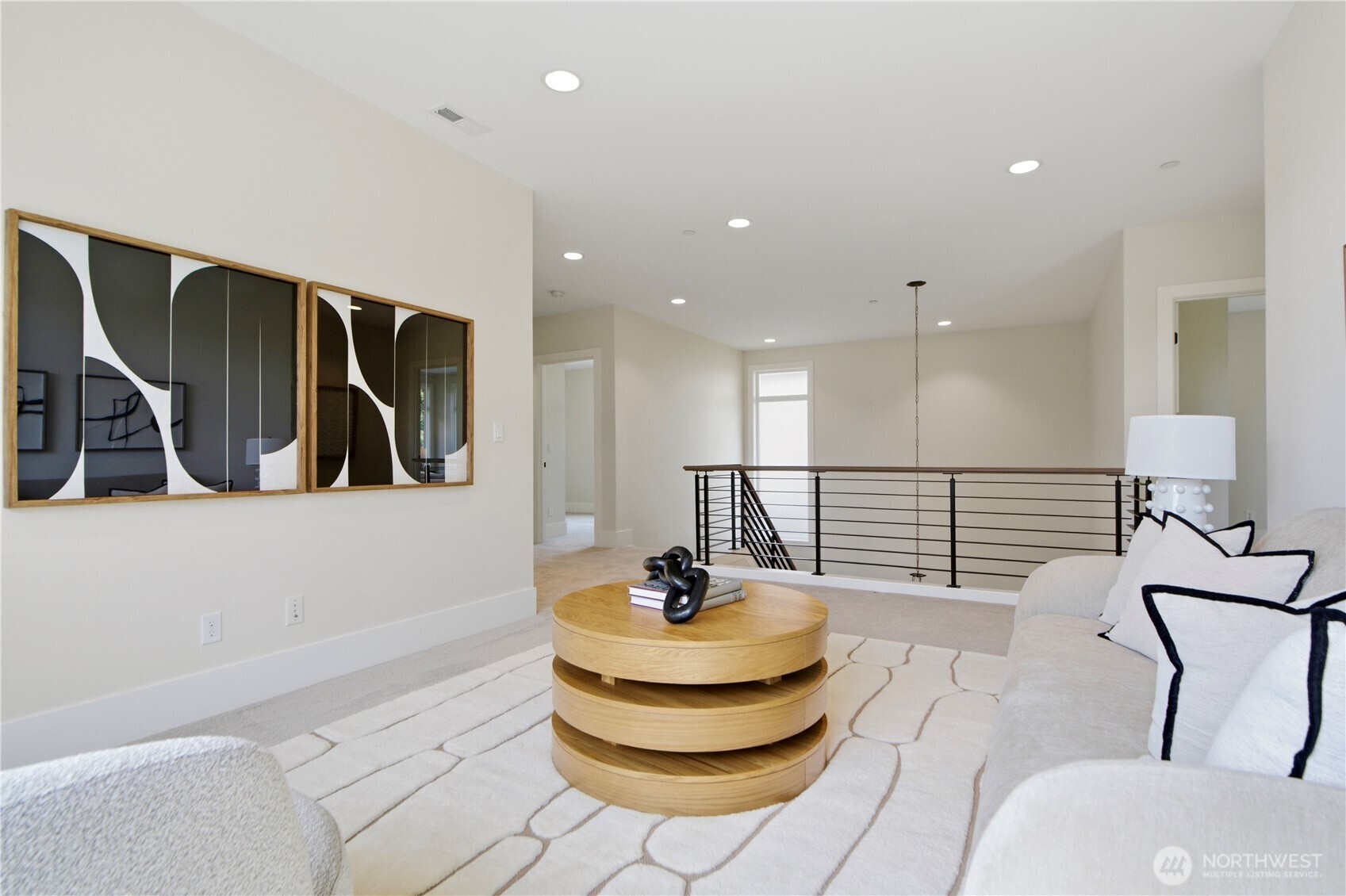 Alternate view of the upper-level loft showcasing the sleek, modern railing and open sightlines