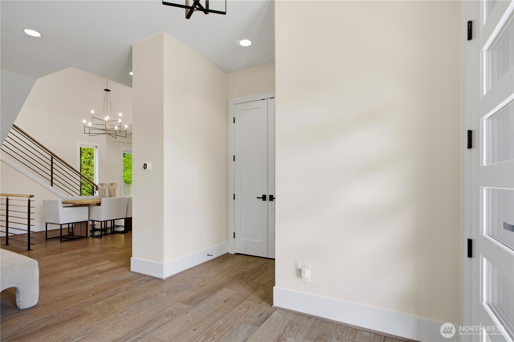 Main-level front entry with double doors concealing a conveniently located coat closet for added storage and organization