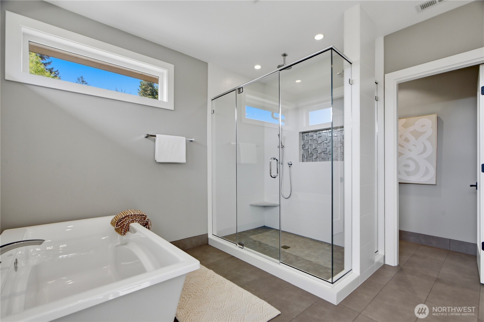 Spa-inspired primary bathroom suite with a large walk-in shower, soaking tub, and private water closet for added comfort and privacy