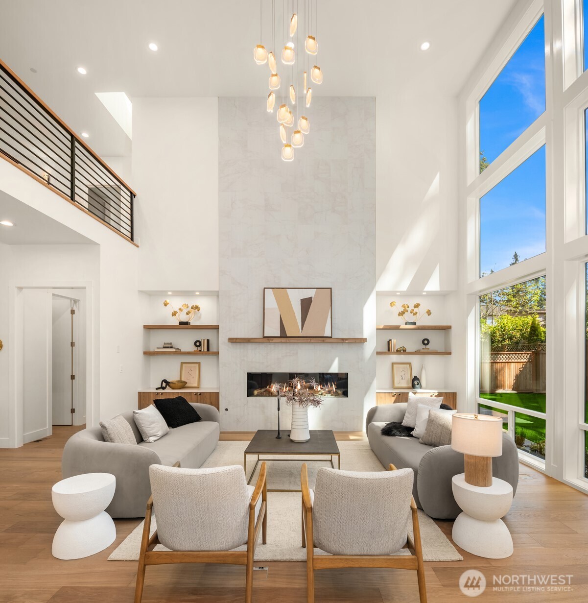 19" ceiling, walls of windows, and dramatic 72" double glass fireplace with floor to ceiling tile frame the great room!
