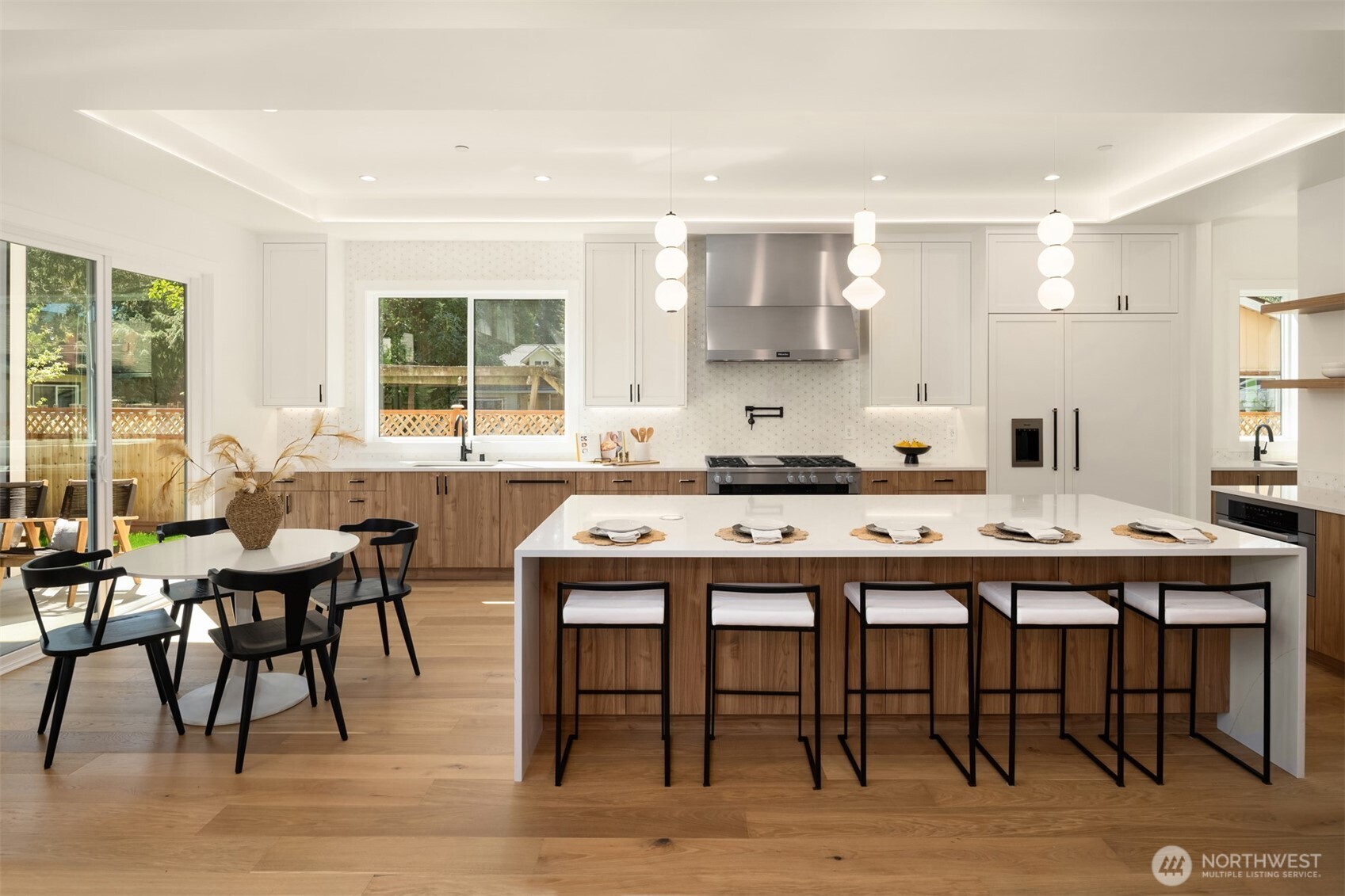 Large waterfall center island, custom cabinetry make this kitchen warm and welcoming!