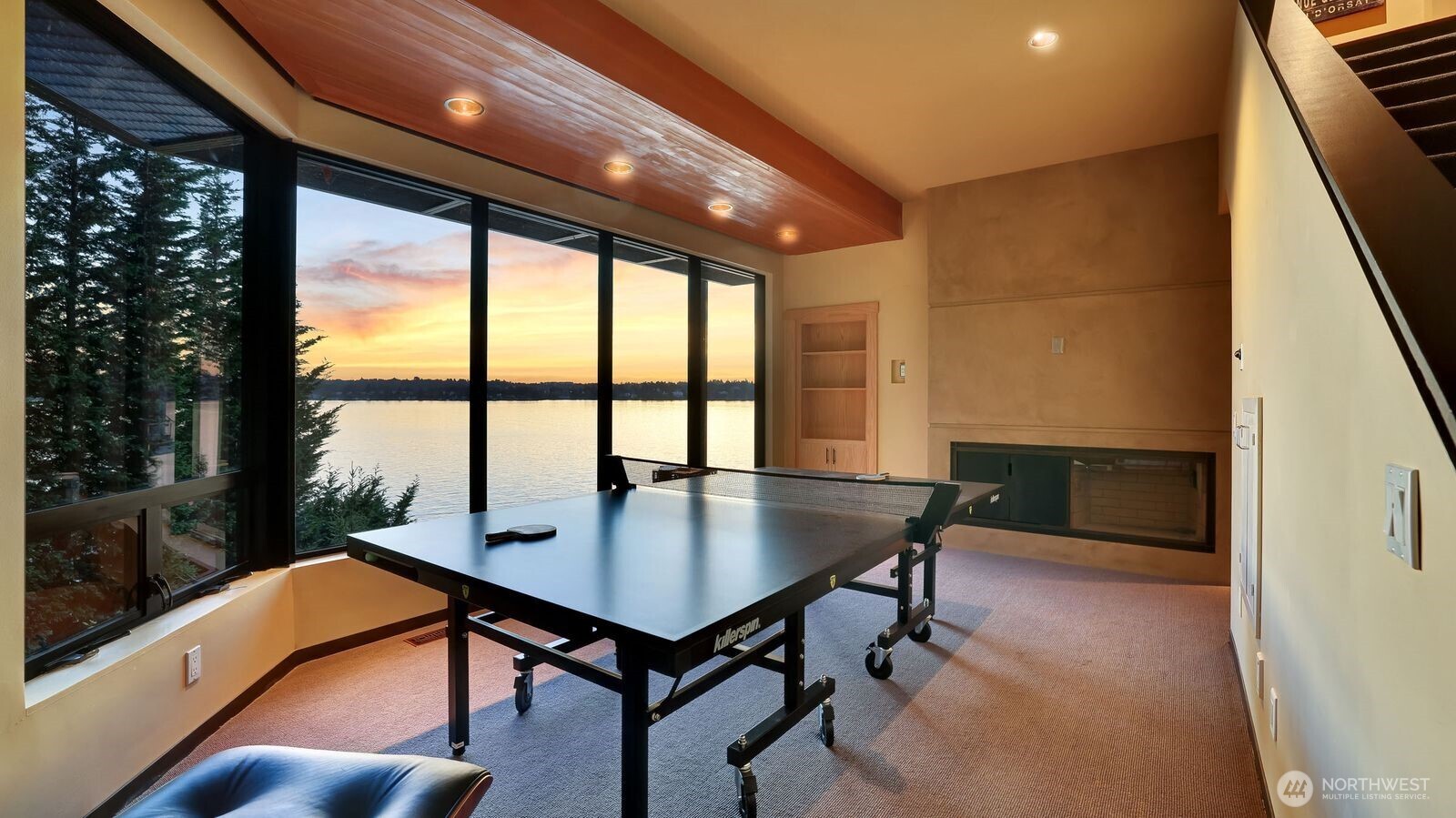 Lakeside level family room with fireplace & secret office behind the bookshelf door
