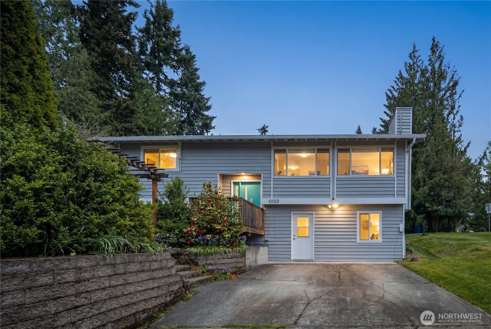 Twilight exterior glowing warmly at dusk, highlighting the inviting atmosphere and beautiful curb appeal