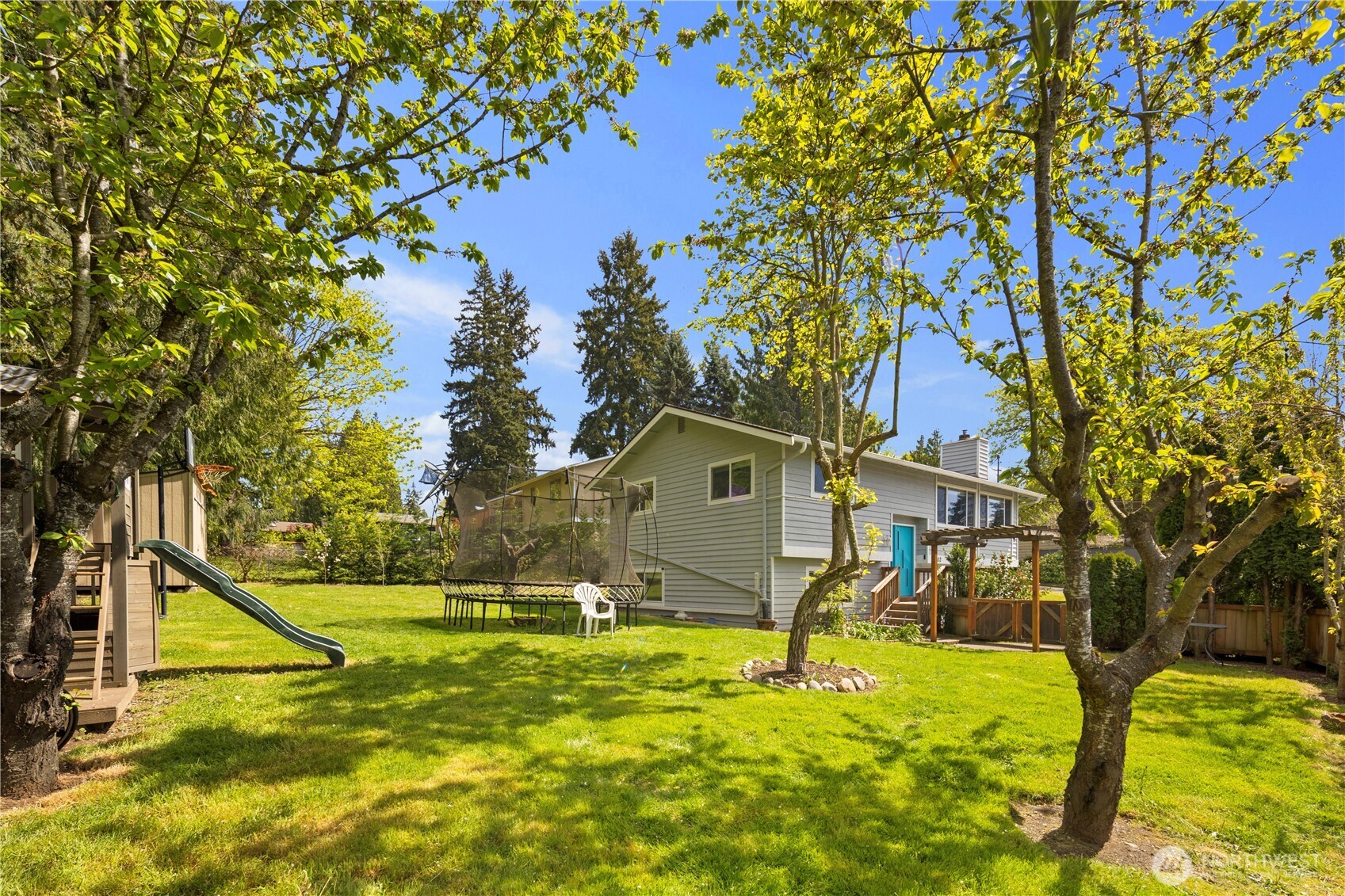 Rear exterior showcasing the home’s updated design, generous lot, and peaceful Rose Hill setting
