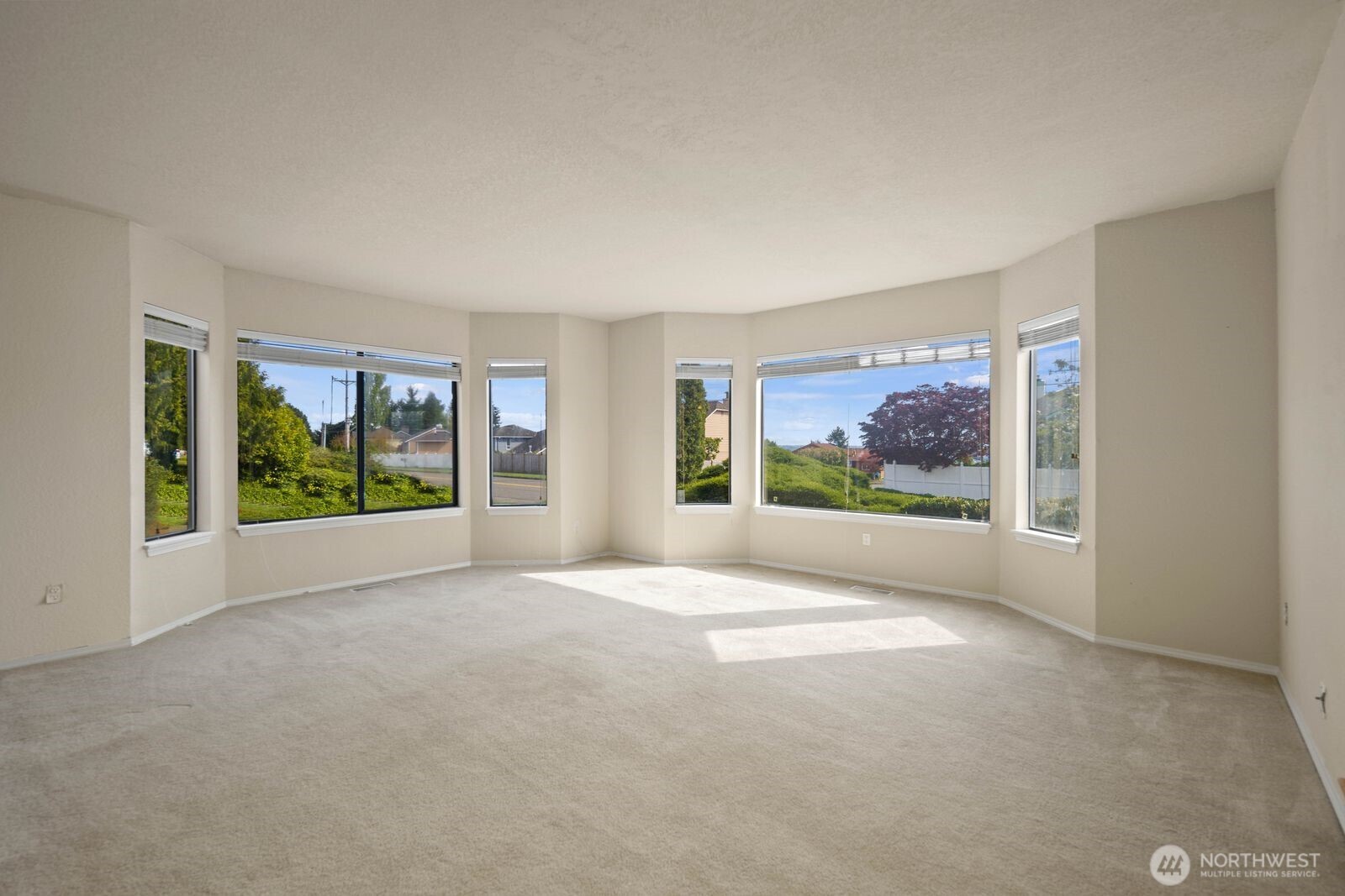 Bright living area with large windows and flexible open space for a variety of layouts