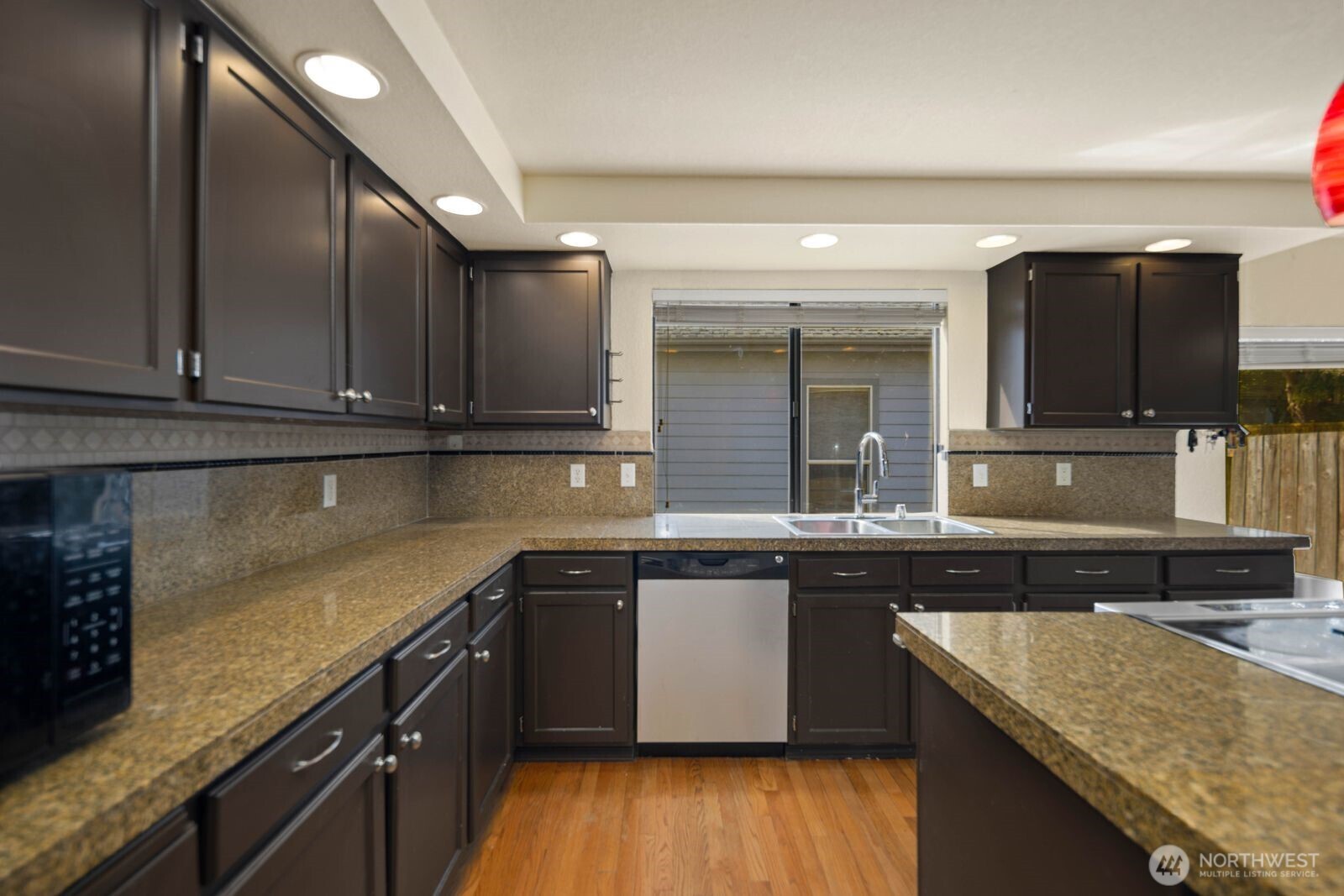 Spacious kitchen with center island, bar seating, and open flow to the dining and living areas.