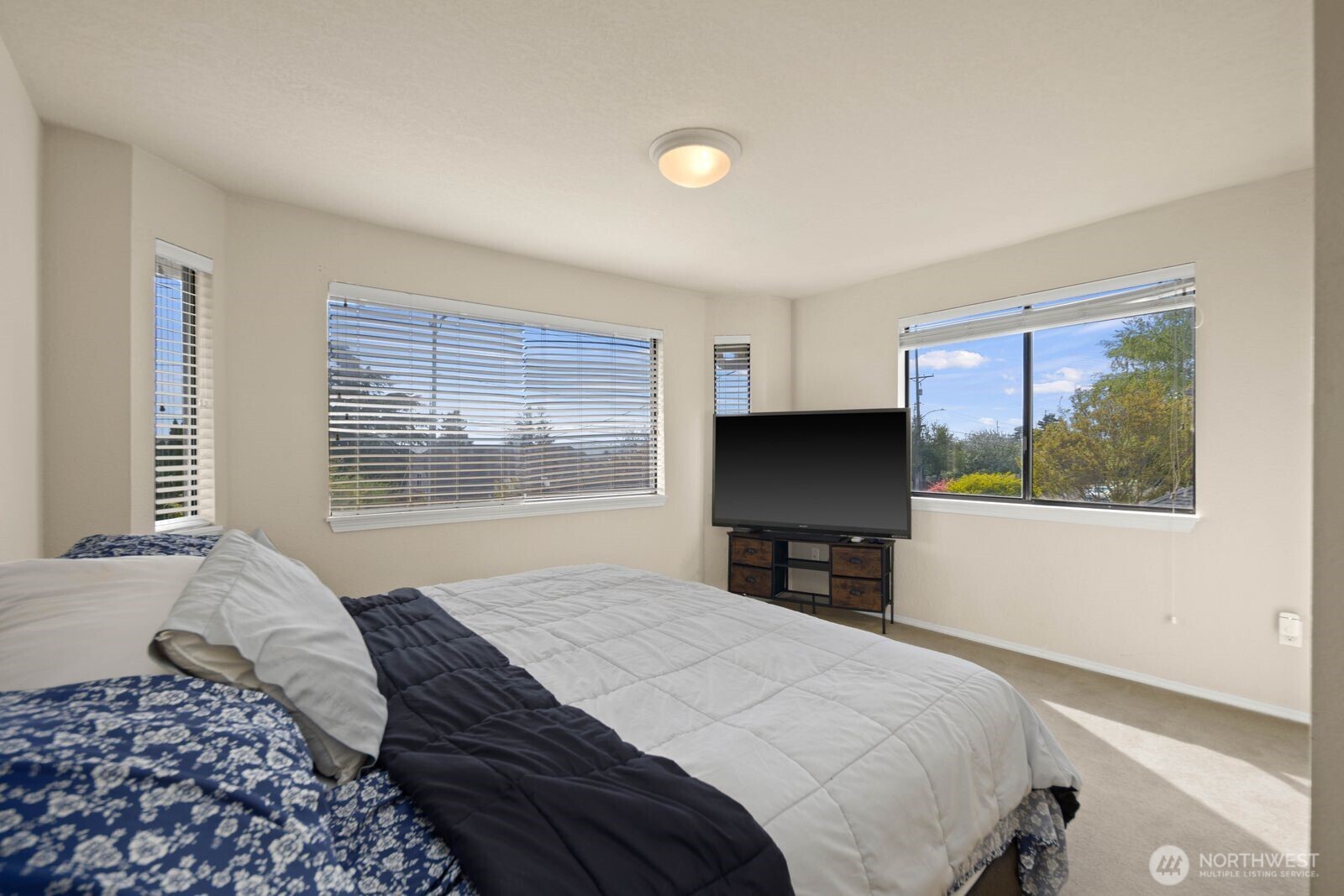 Secondary bedroom with window, closet space, and neutral finishes.