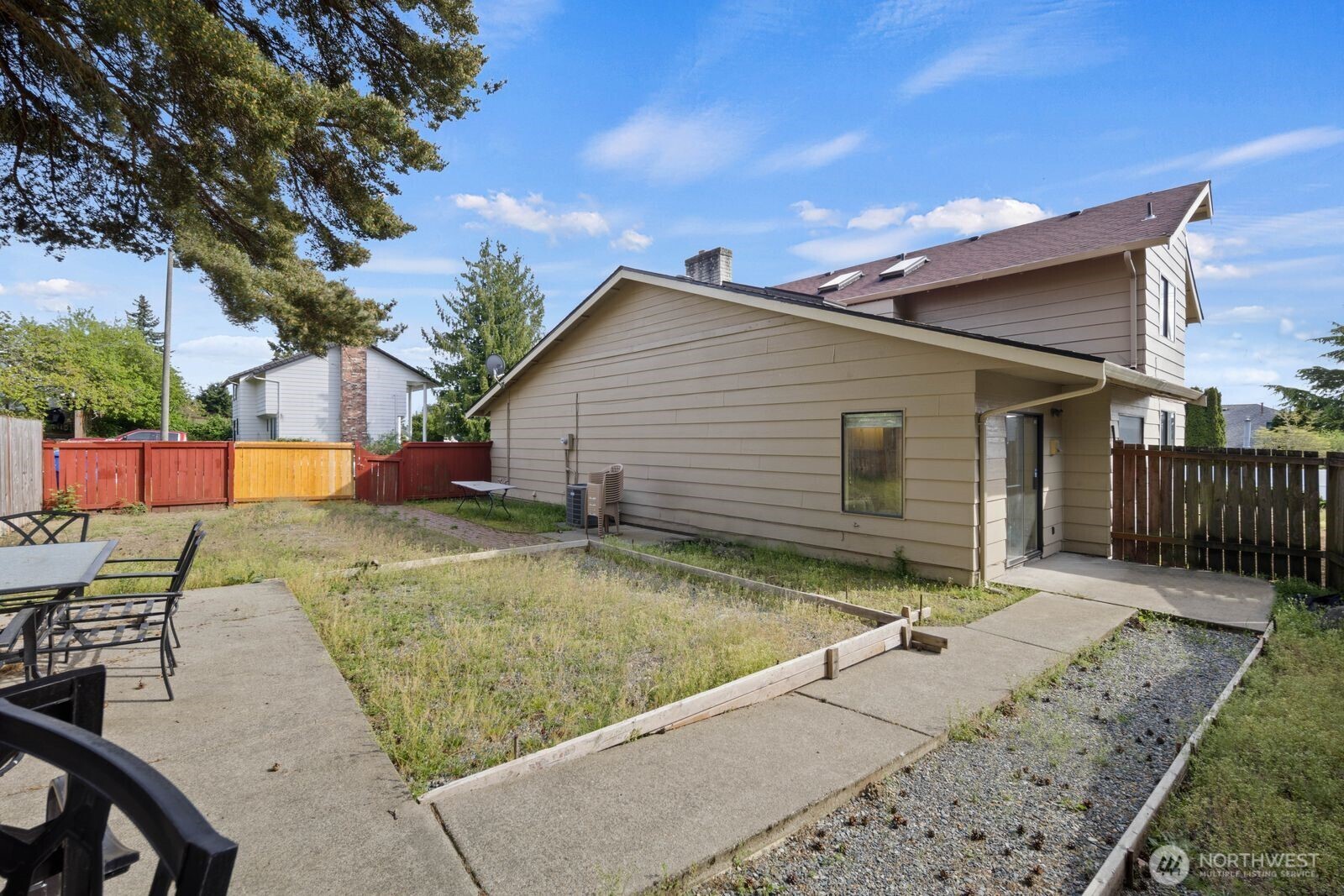 Side yard with walkway access and additional outdoor space.