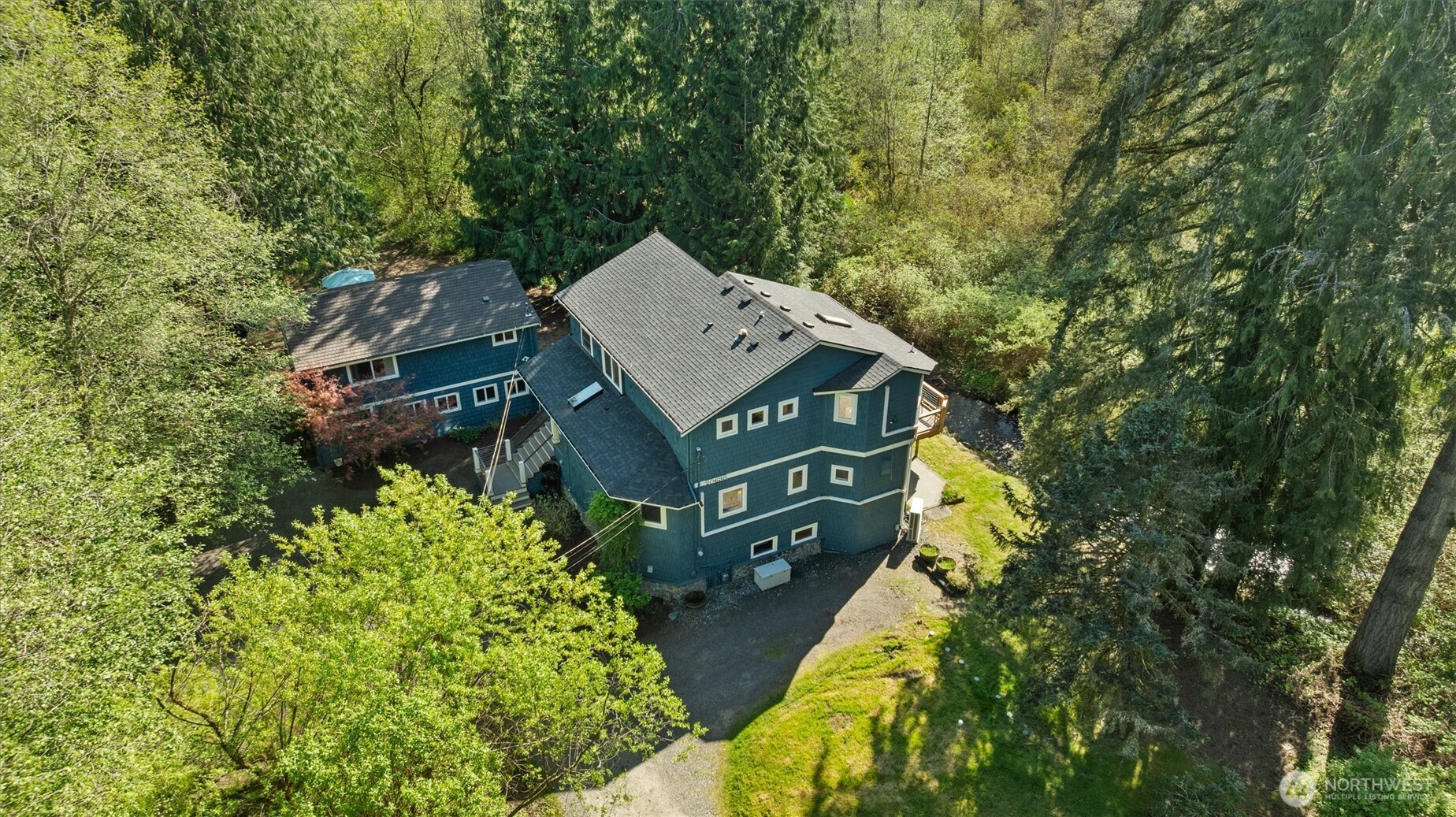 Property includes a 3,004 square foot main house, and a detached 1,408 square foot ADU shown to the left in this photo.