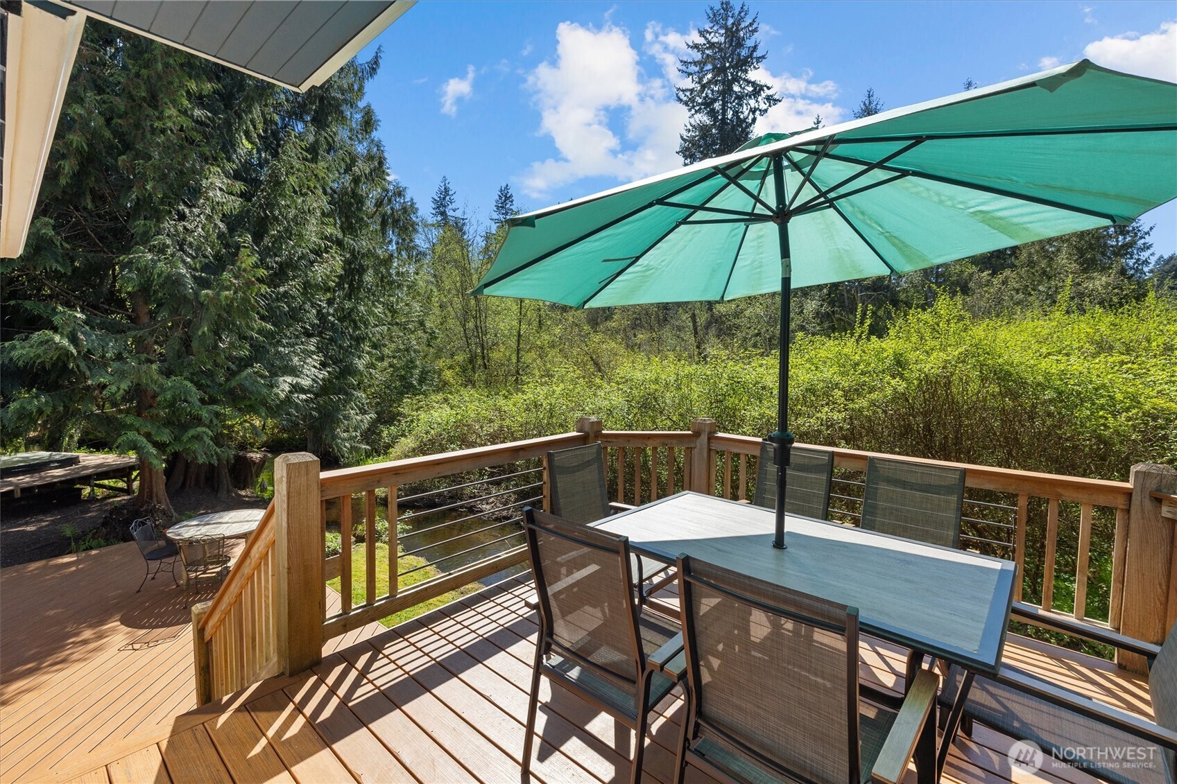 Deck off the kitchen with privacy in all directions.