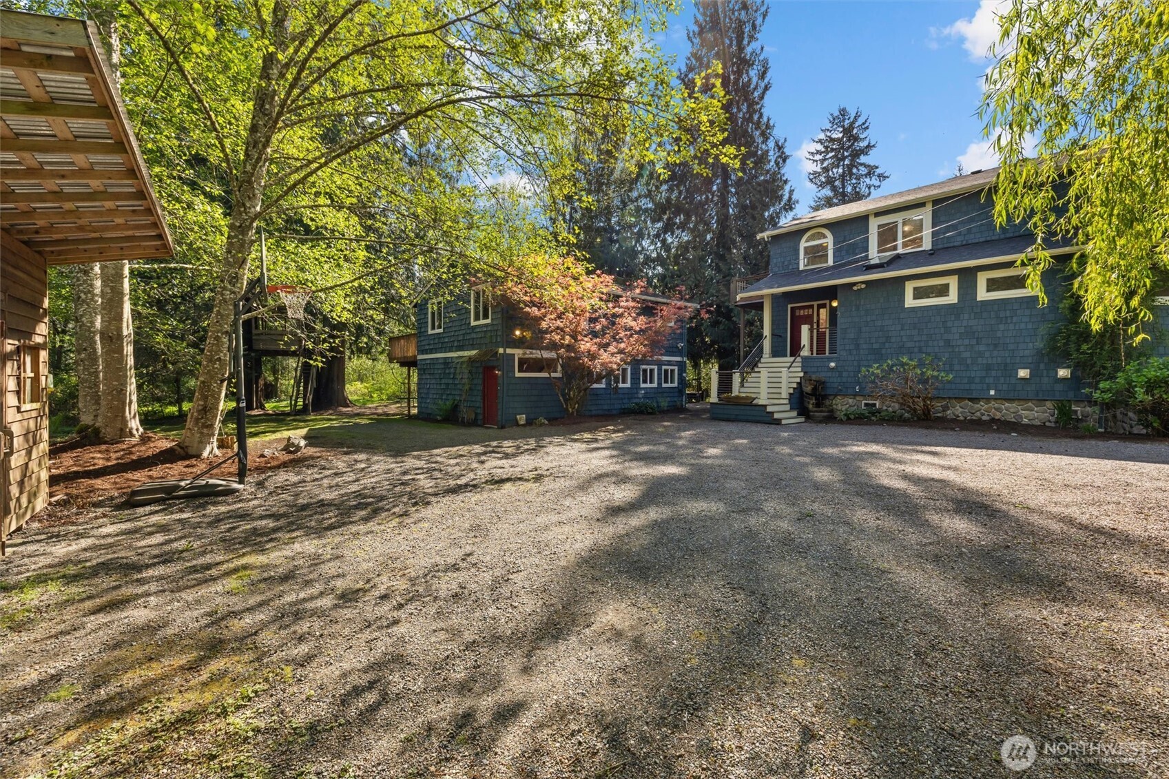 This photo shows the main house on the right, ADU straight ahead, and the edge of the garden shed on the left.
