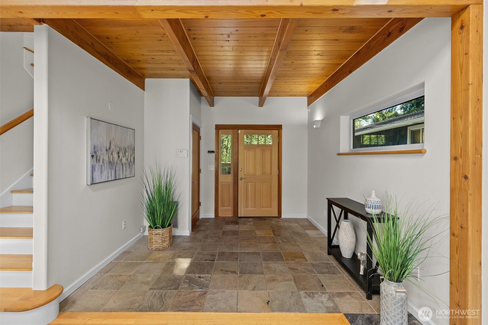 Spacious entry with a beautiful pine ceiling.