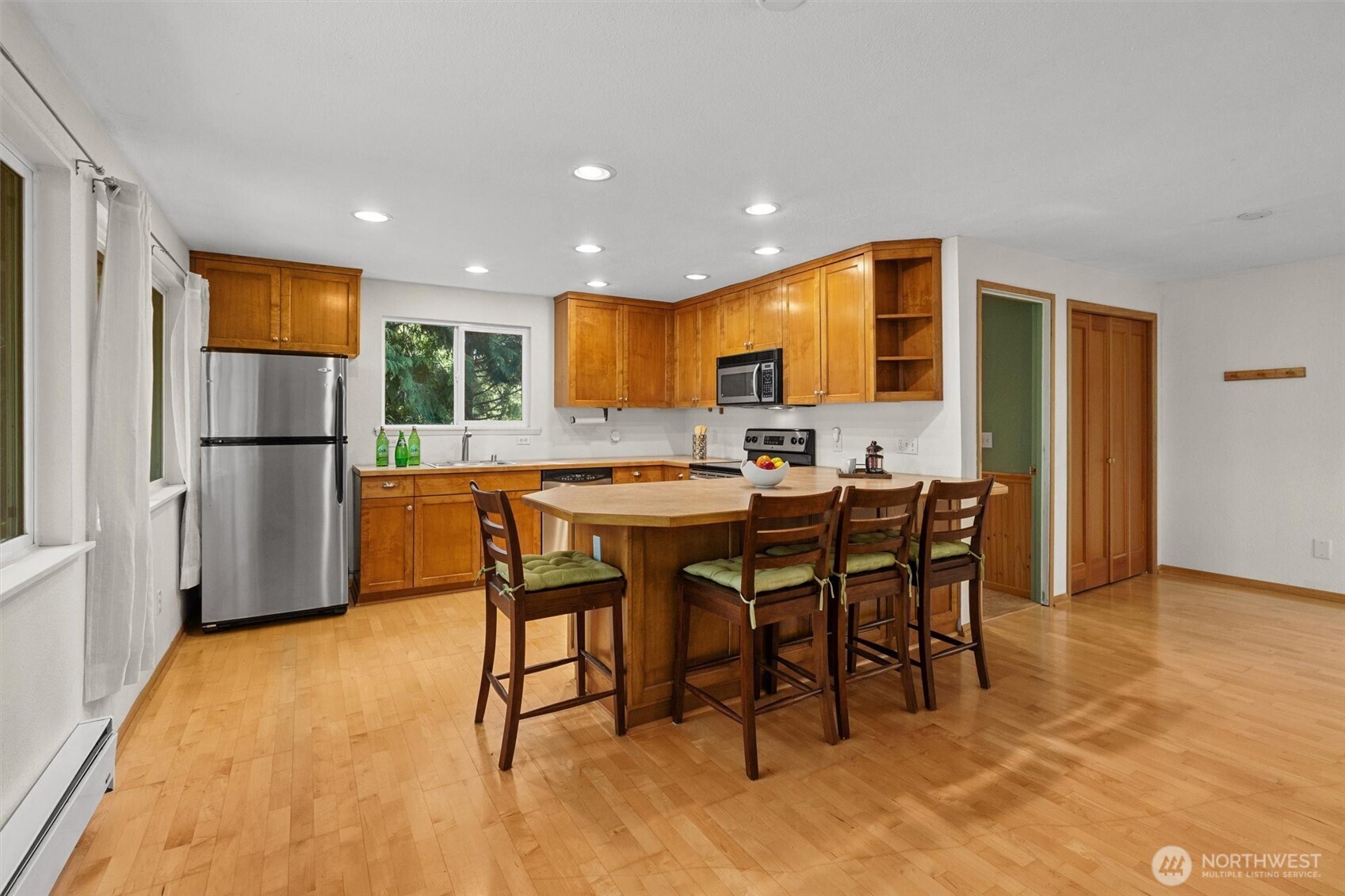 Kitchen has lots of cabinets and eating bar.  Appliances can stay.