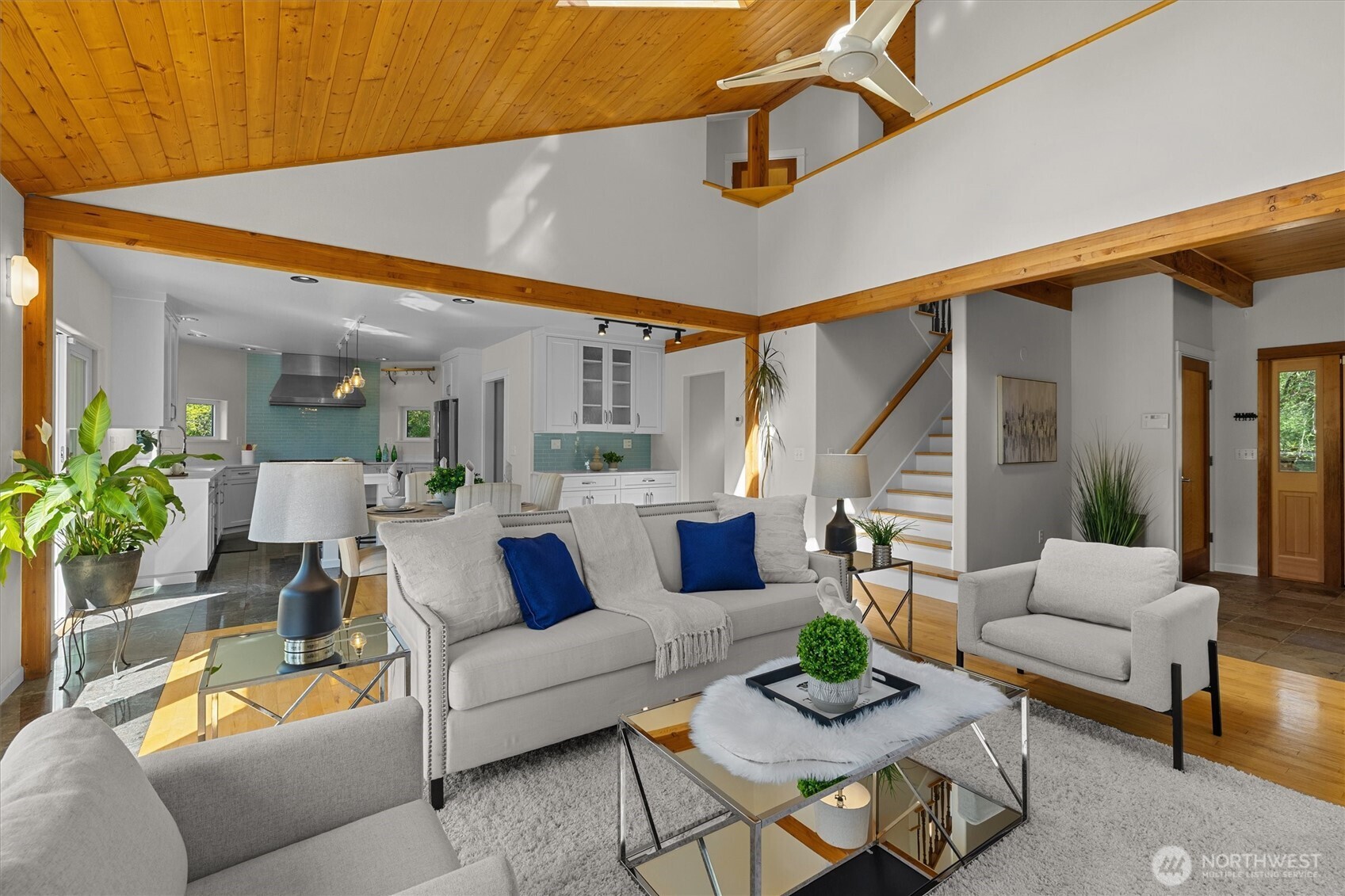 From the top of the stairs there is a loft area looking down over the main living space.