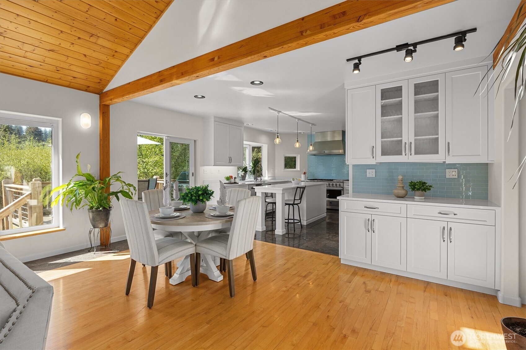 Large dining area including bar with beautiful built-in cabinets.