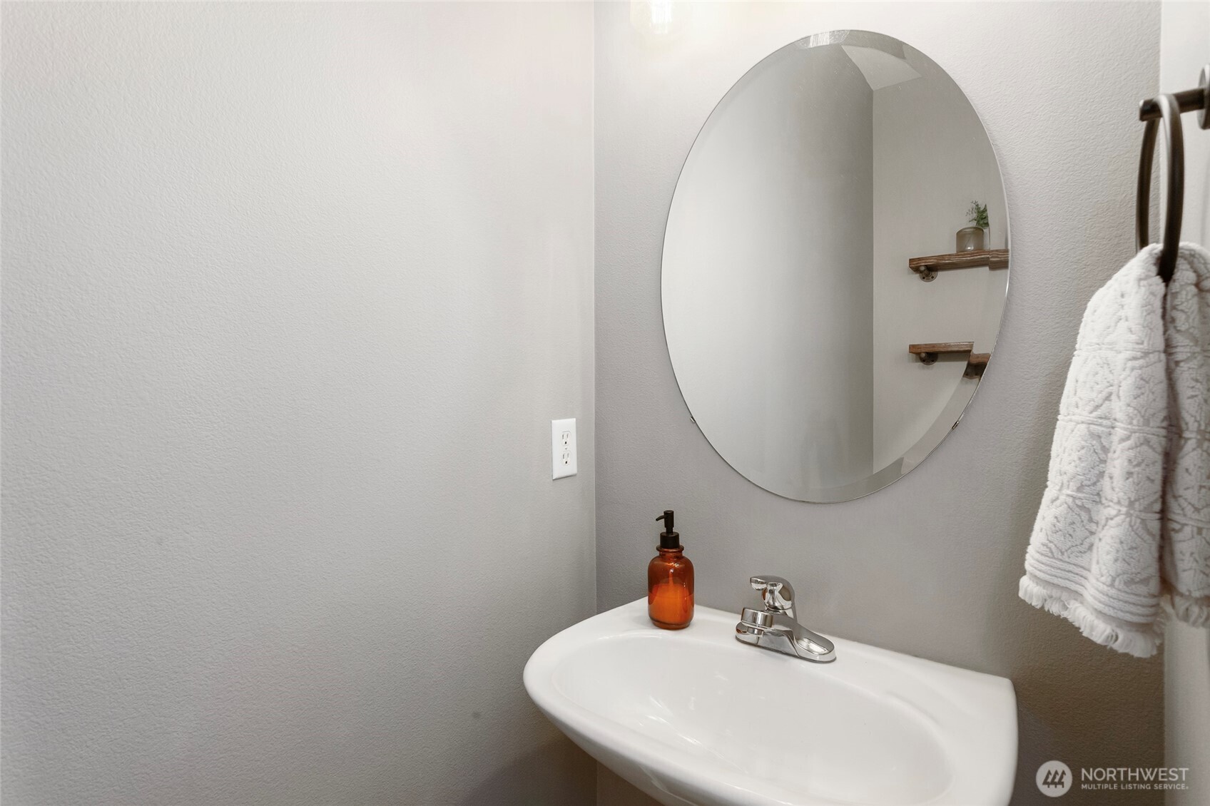 Private main-level powder room thoughtfully tucked away from high-traffic living areas for added privacy and convenience. This well-placed half bath offers easy access for guests while maintaining a quiet, discreet location off the main floor—ideal for everyday use and entertaining alike.