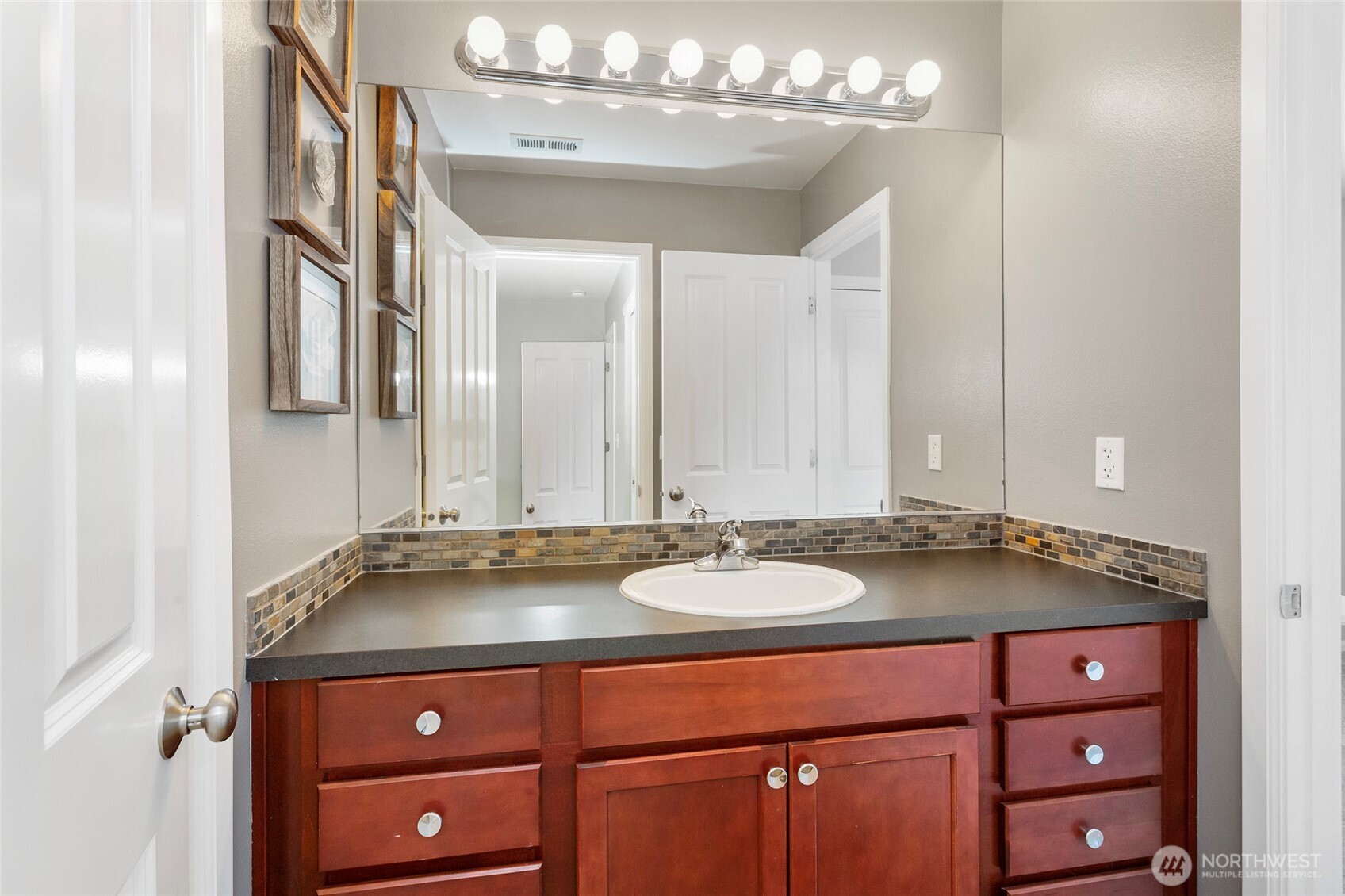 Jack-and-Jill bathroom designed for privacy featuring separate access from both bedrooms, a spacious vanity with ample counter space, and bright lighting. The layout includes a private enclosed toilet area and a tub/shower combination, allowing multiple users to comfortably share the space while maintaining privacy and functionality.