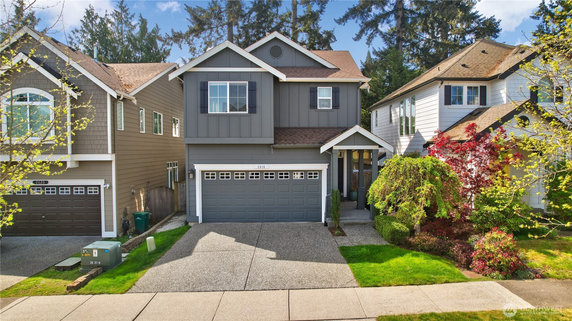 Charming street presence with classic Craftsman-style architecture, a covered front entry, and a two-car garage. The well-maintained exterior is complemented by manicured landscaping, mature trees, and a welcoming driveway that adds to the home’s strong curb appeal.