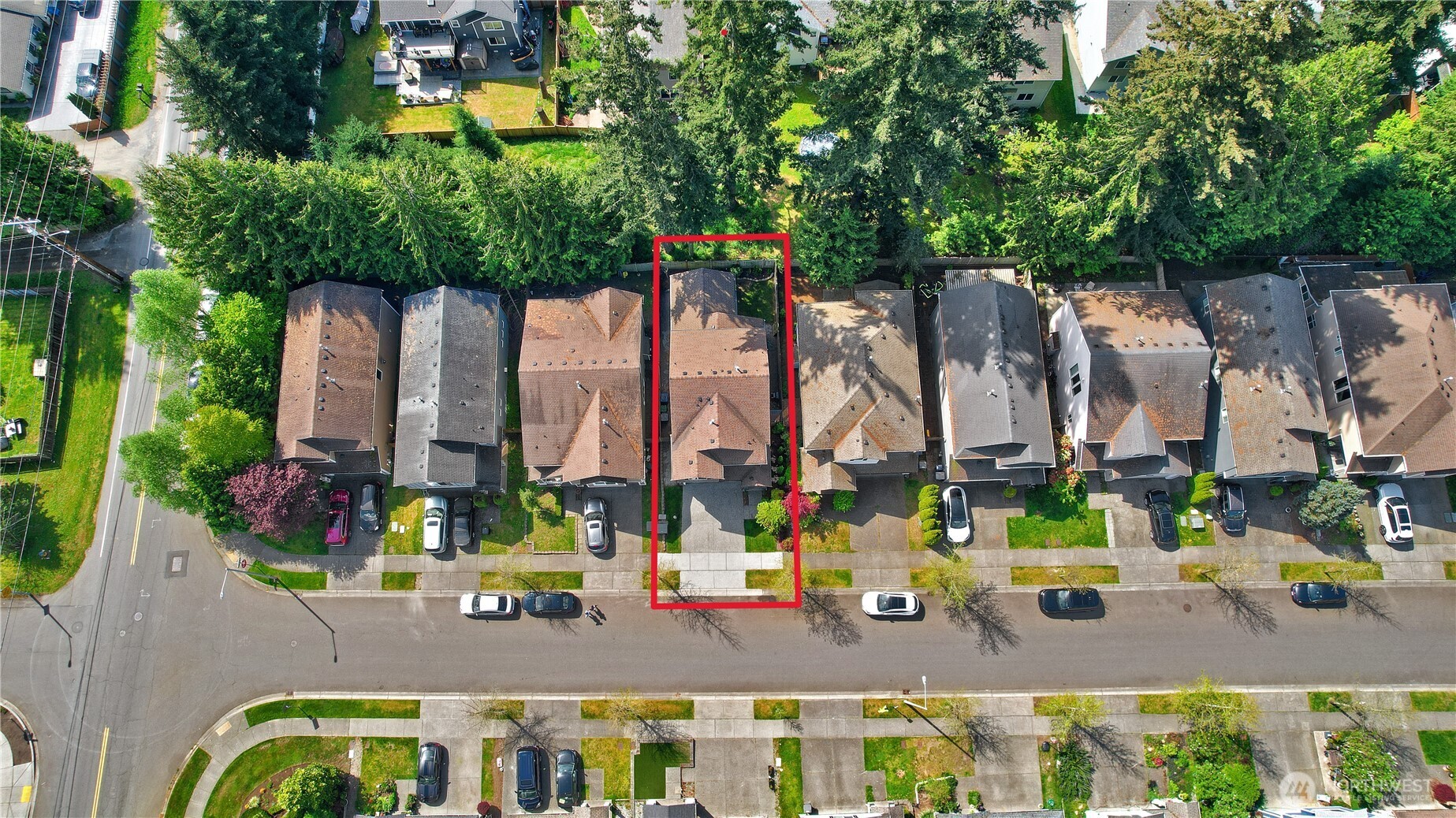 Aerial view highlighting the home’s prime location within the desirable Acadia community, featuring tree-lined streets and a welcoming neighborhood layout. Residents enjoy close proximity to the community playground and open play field—perfect for outdoor recreation, gathering, and everyday enjoyment just steps from home.