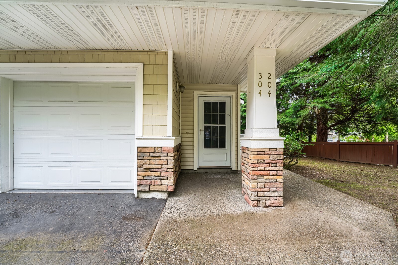 The garage door leading to the generous one car garage of this condo. After parking, you can exit your vehicle directly inside your secure vestibule.