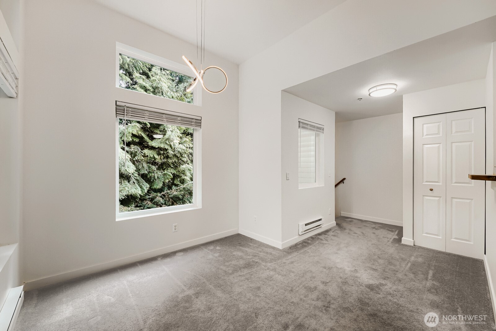 The staircase takes you from the vestibule directly into this top floor, corner unit. The dining area is to the left, coat closet and kitchen to the right.