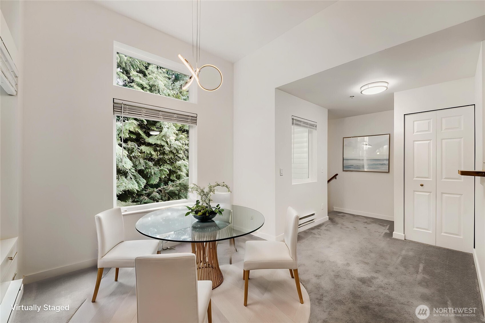 Virtually staged dining area. There is plenty of room for a large dining ensemble. The lovely trees are enjoyed through the oversized windows.