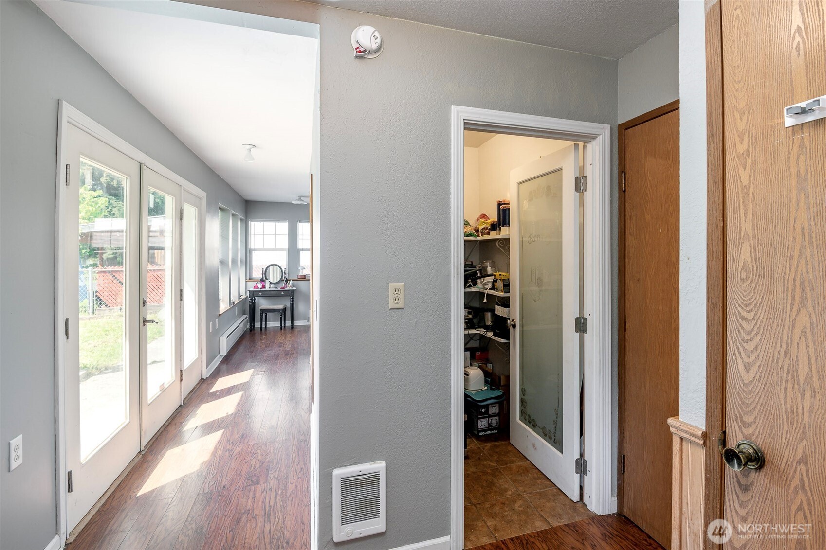 Hall to bonus room, showing walk in pantry, door to garage