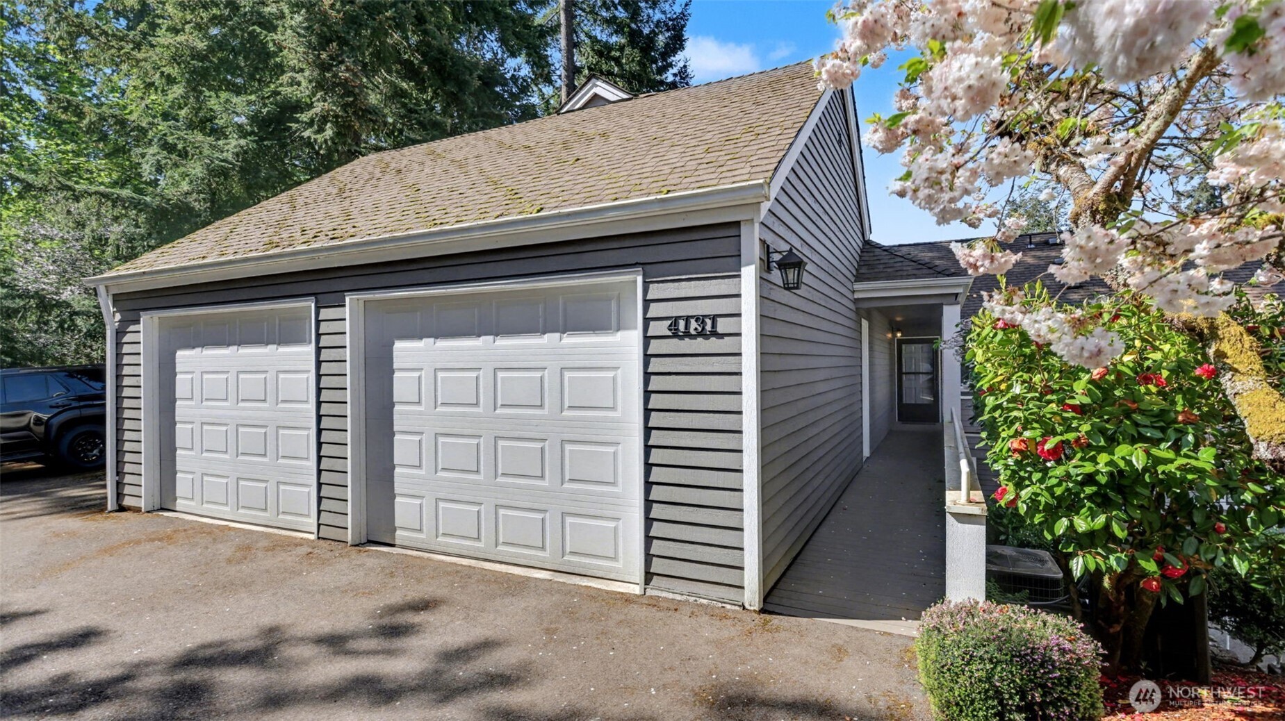 2 car garage with 2 shared guest parking spaces.