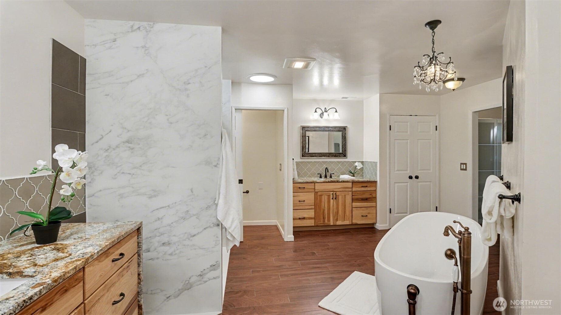 Primary bath also features a new shower, and two large walk-in closets with custom shelving.