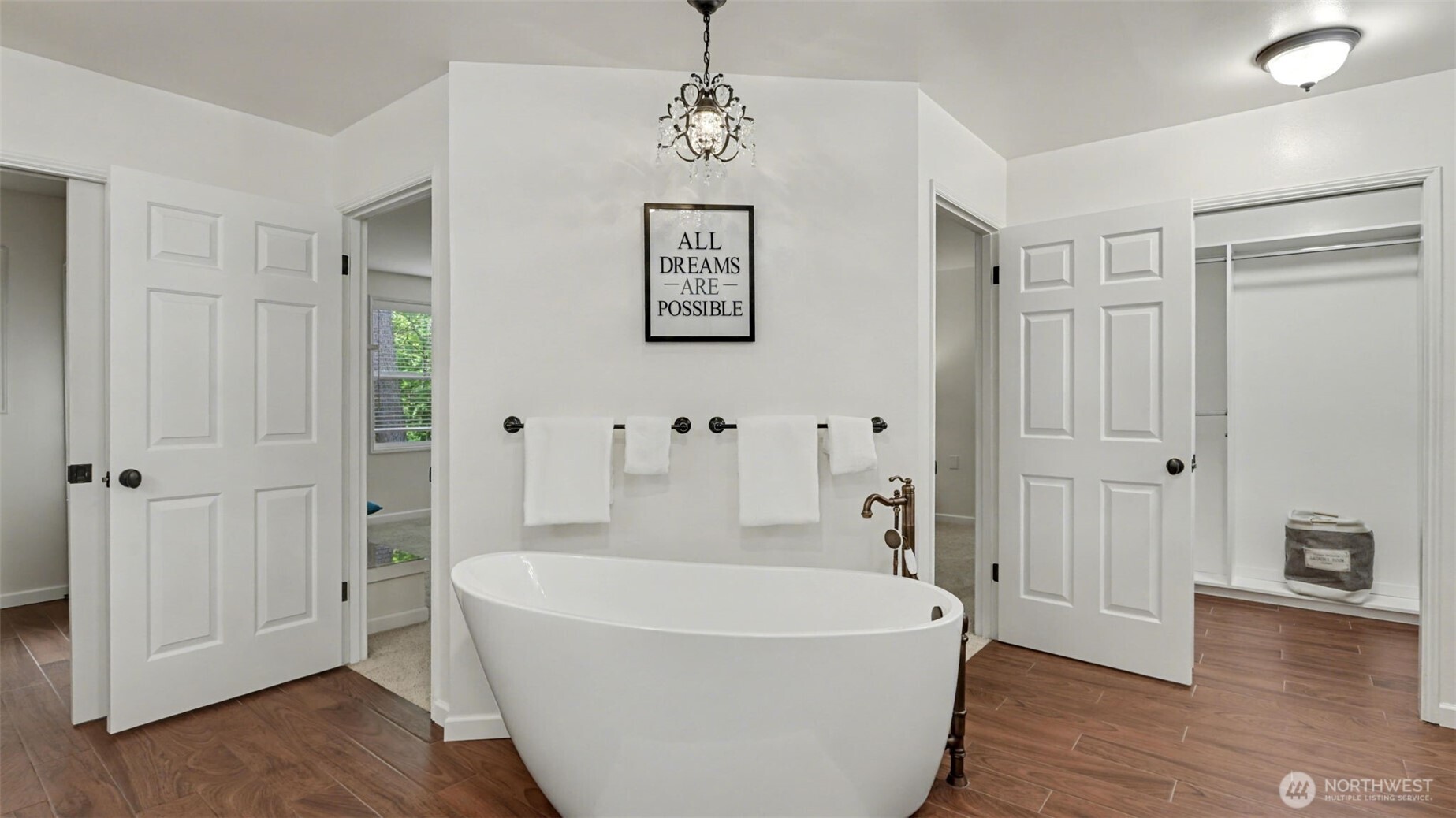 High end soaker tub anchors the primary bathroom.